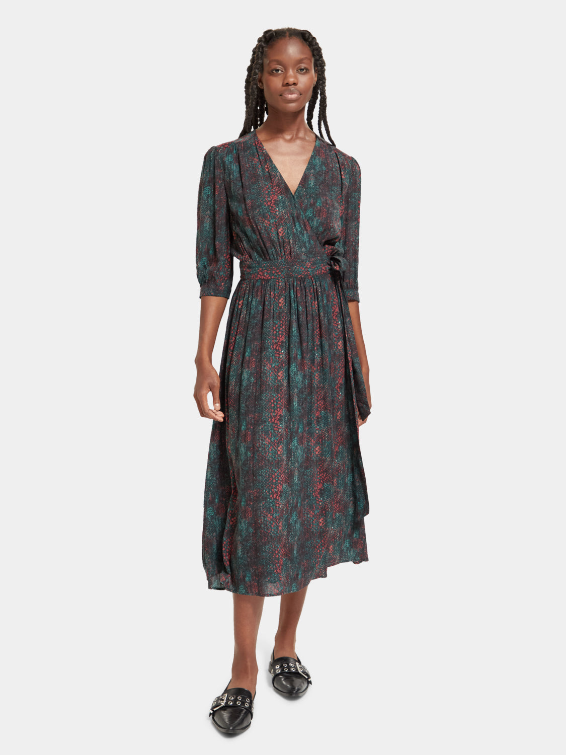 SCOTCH & SODA midi wrap dress showing a floral pattern, V-neckline, and long sleeves on a model.
