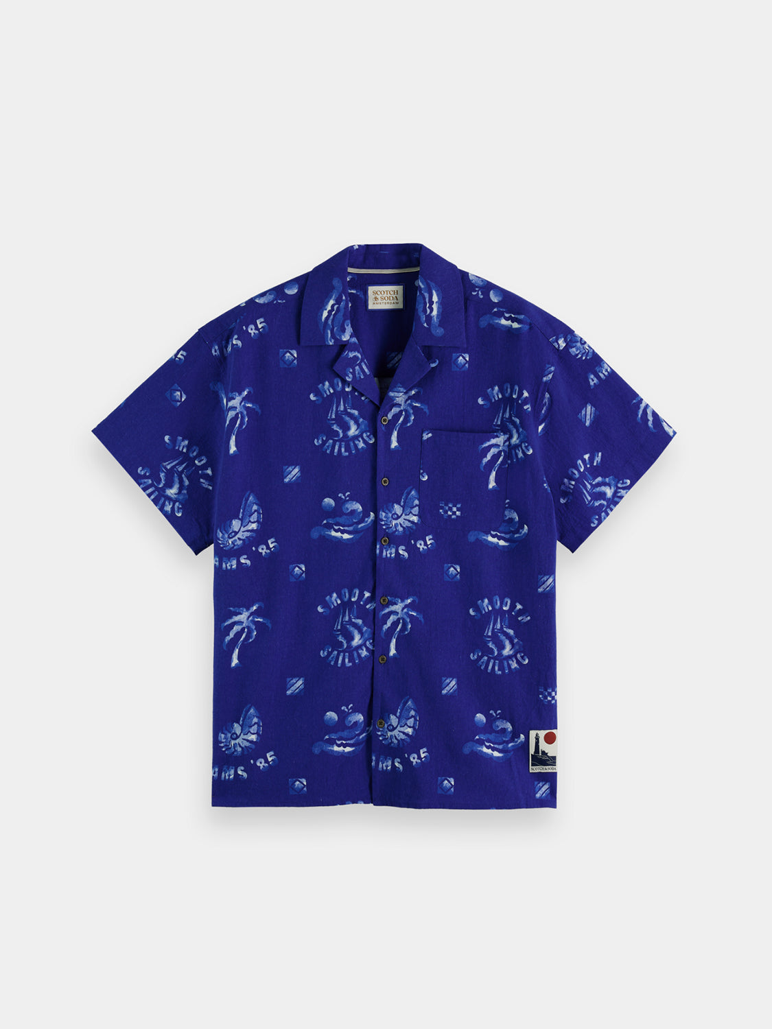 Printed Scotch & Soda short-sleeve camp shirt with tropical floral pattern, lightweight fabric, and button-front design.