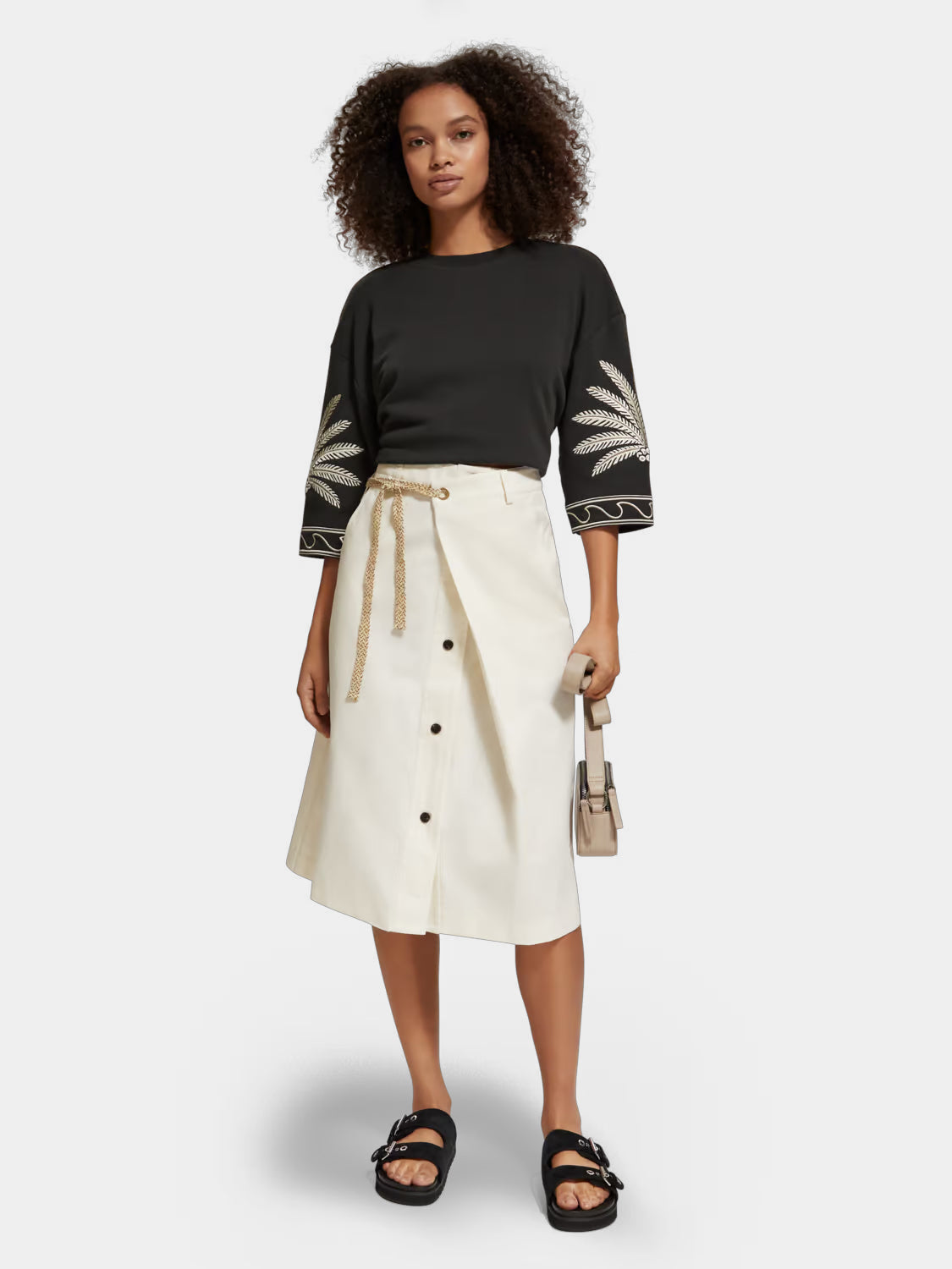 Wrap front midi skirt by Scotch & Soda, featuring a stylish design and neutral color, shown on a model.