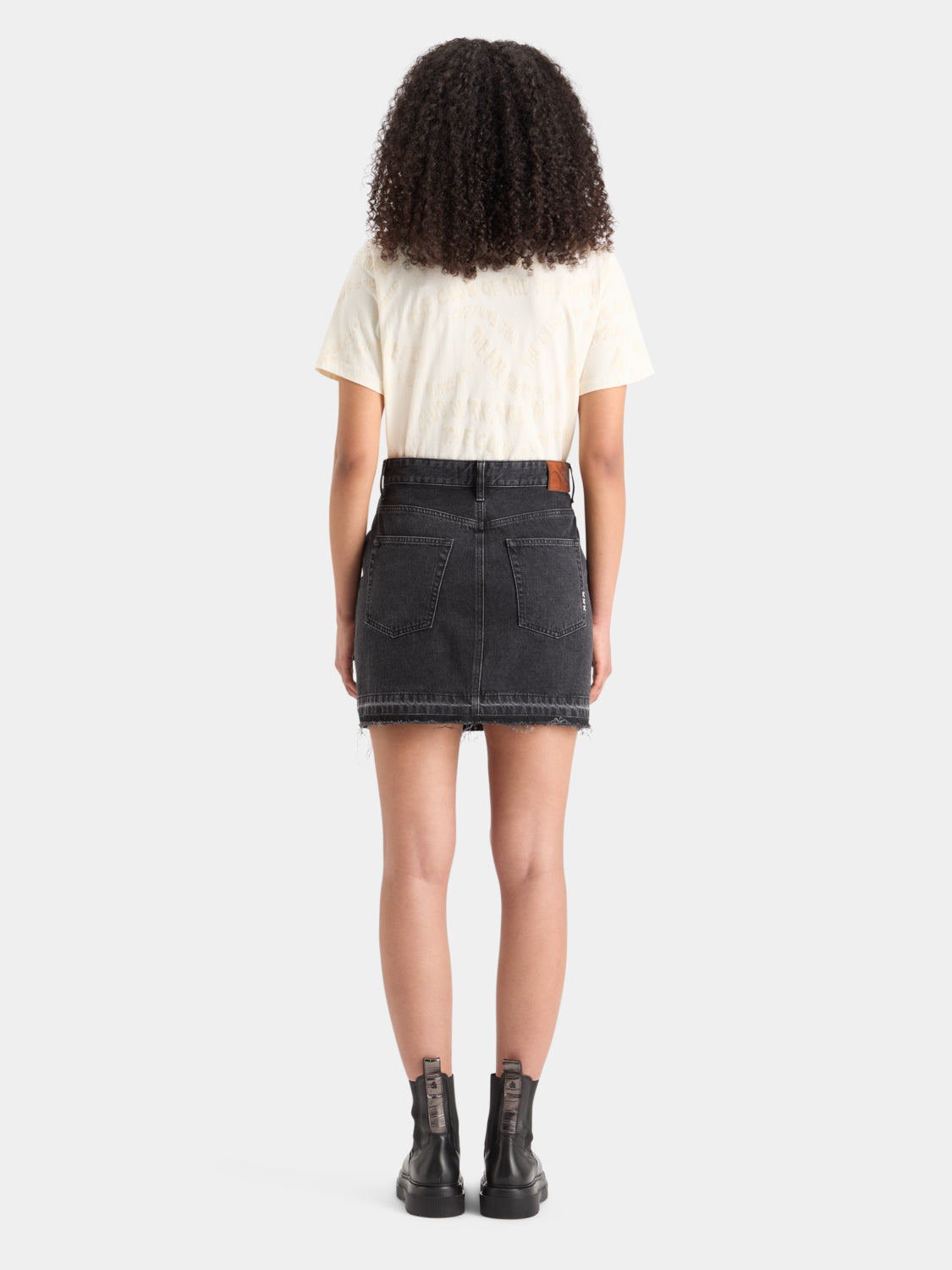 Denim cargo mini skirt from Scotch & Soda with front pockets and distressed details, back view showing classic denim stitching.