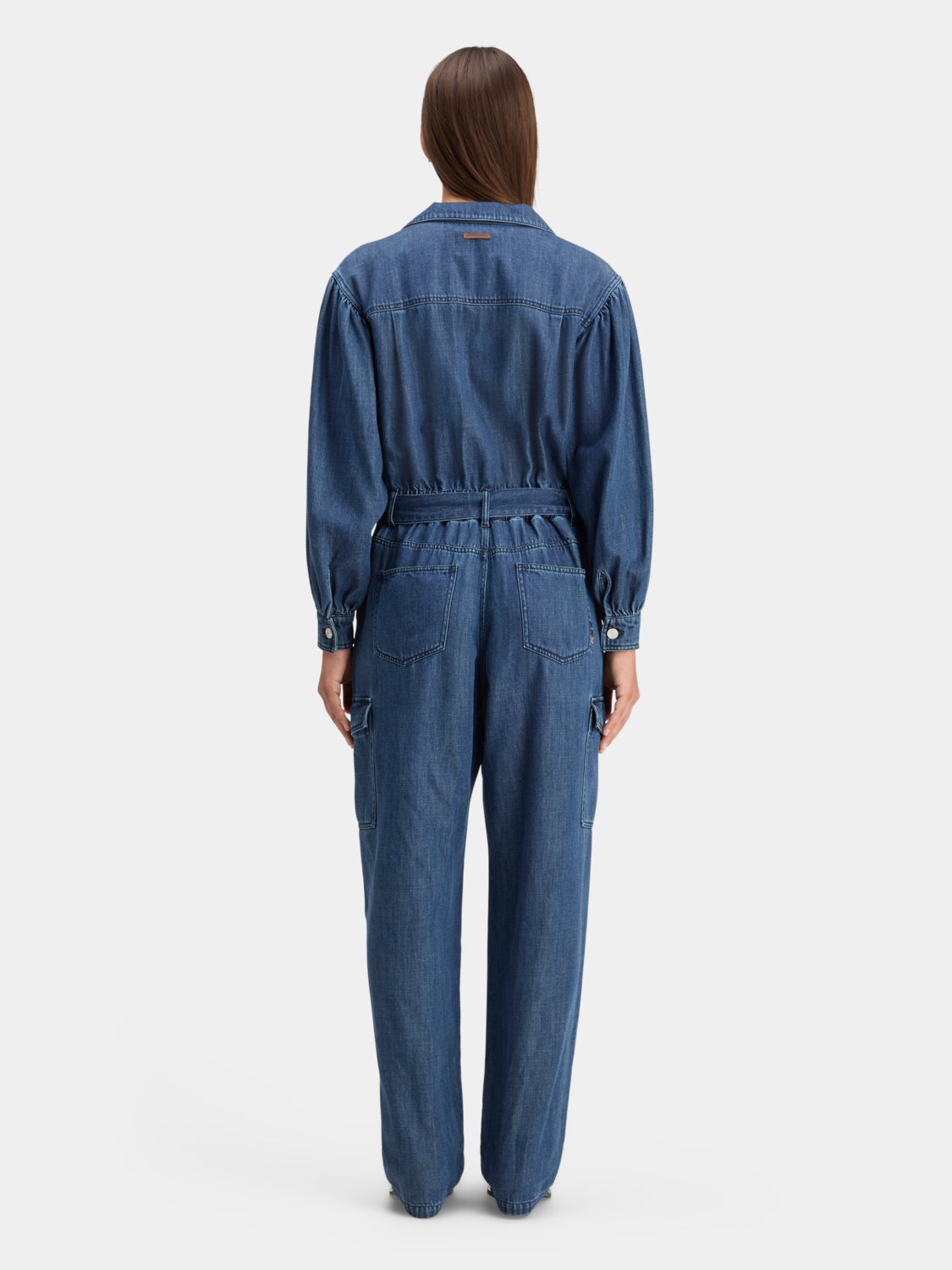 Back view of a stylish denim jumpsuit by Scotch & Soda, featuring a fitted waist and casual design.