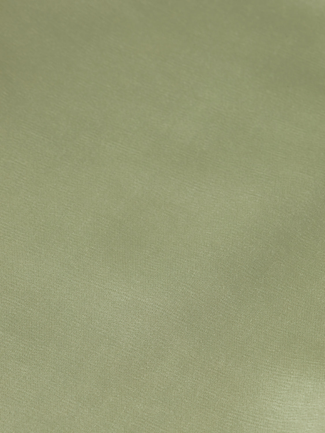 Scotch & Soda Faye tapered pants in dark denim, showing a close-up of the slim-fit design and textured fabric.
