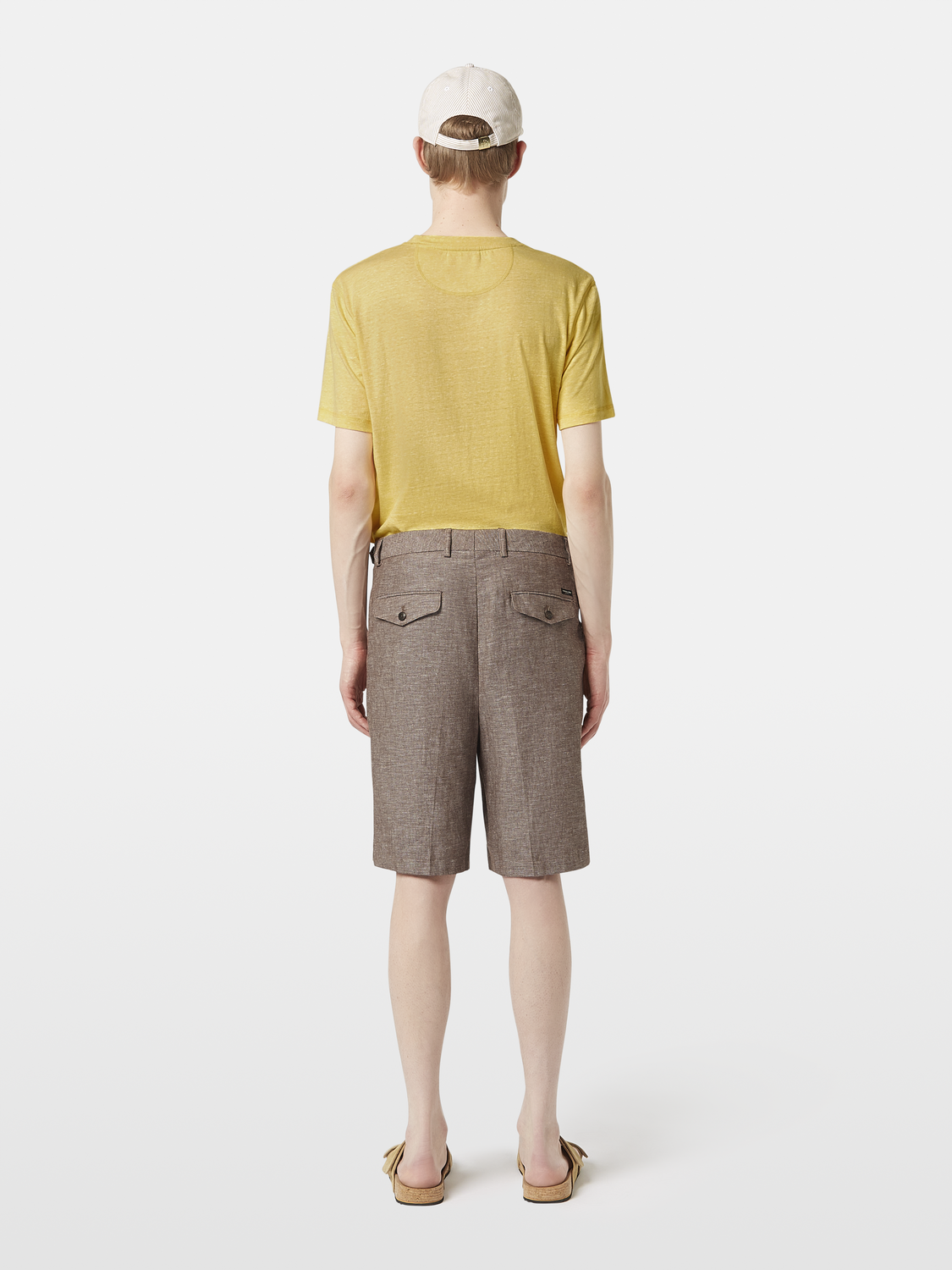 Blue Scotch & Soda pleated shorts with side pockets and a back zipper, displayed from the back view.