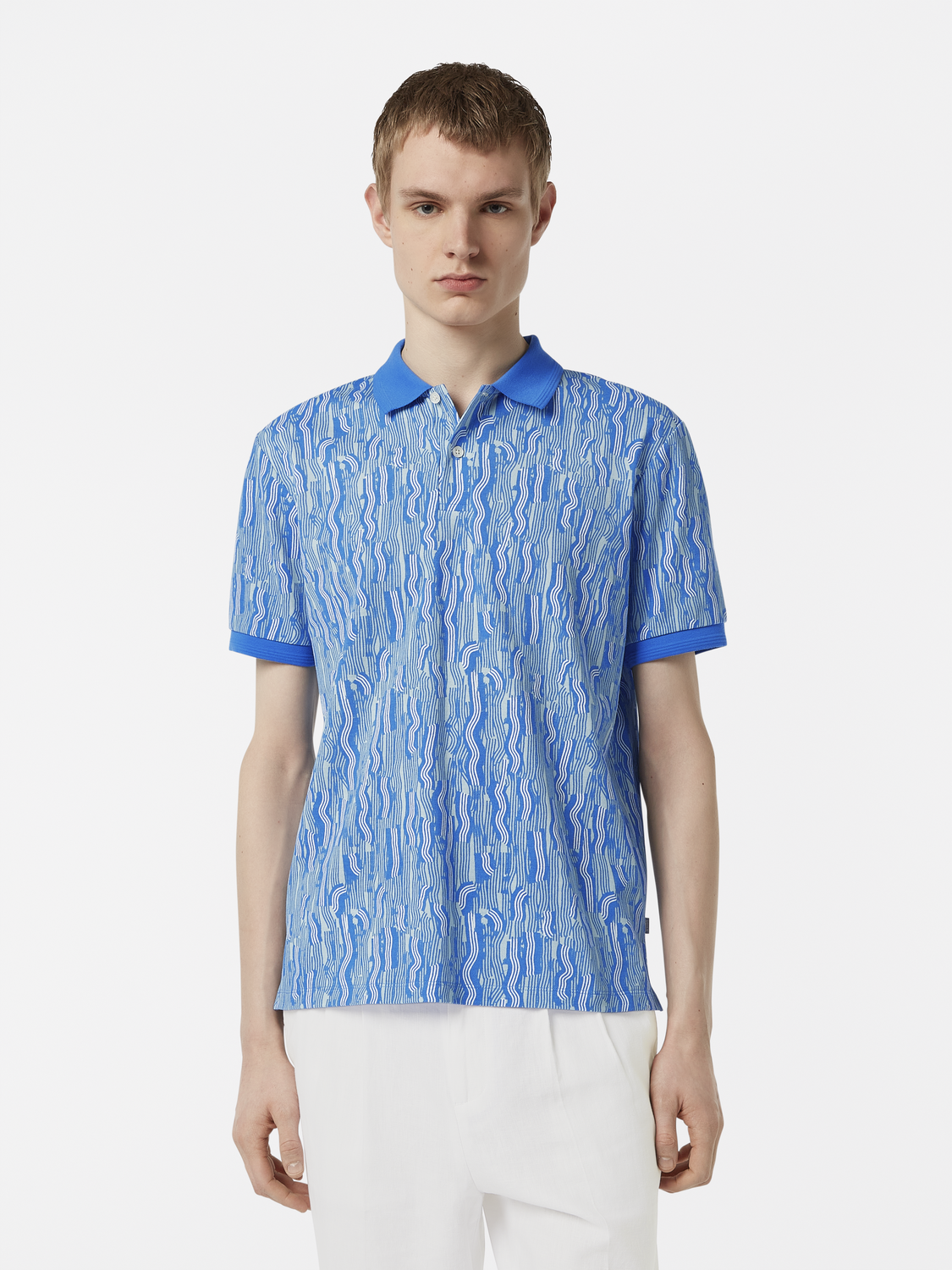 Printed SCOTCH & SODA polo shirt with colorful design, short sleeves, and classic collar, laid flat on a white background.