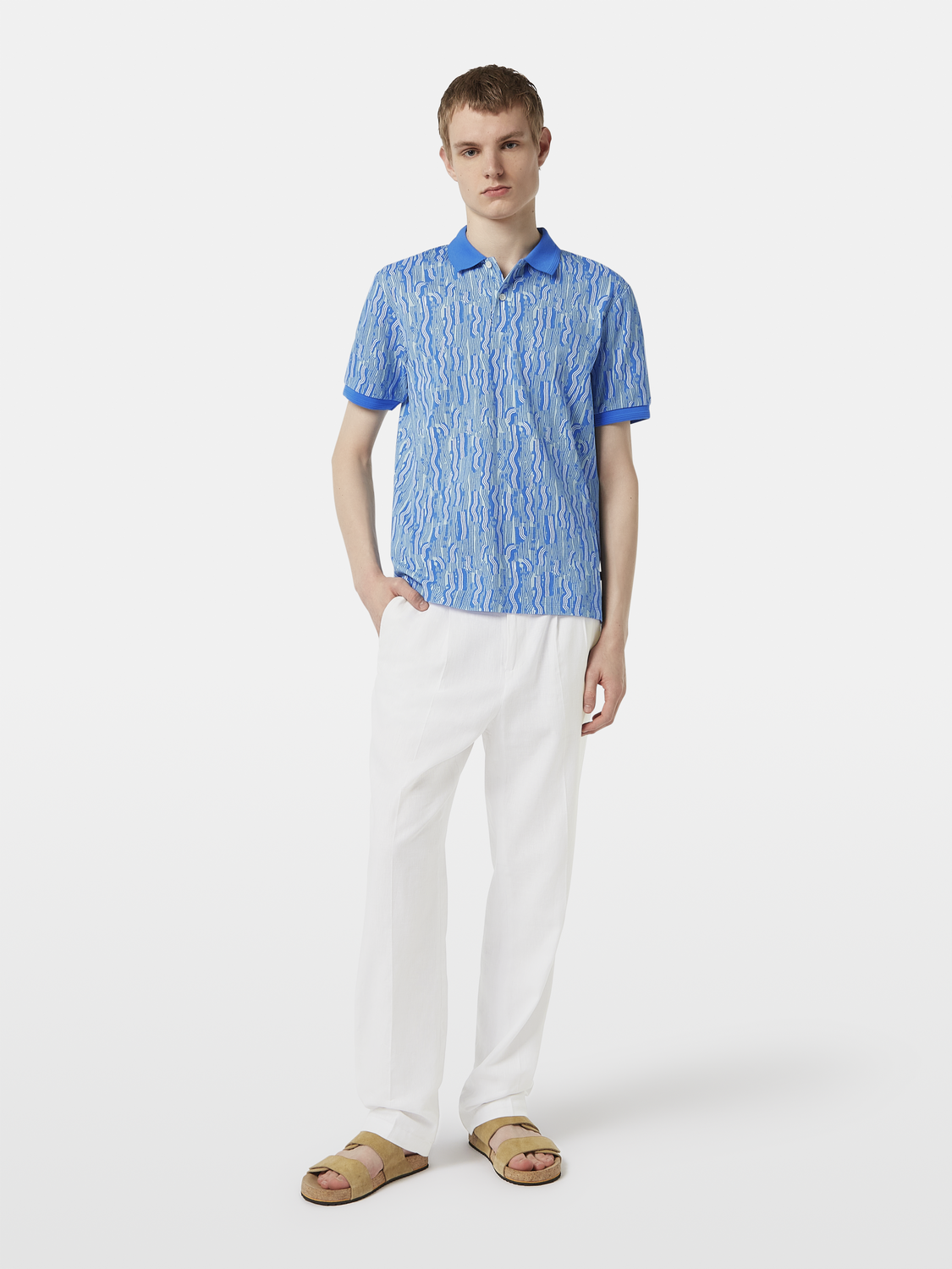 Printed SCOTCH & SODA polo shirt with a colorful pattern, short sleeves, and a classic collar on a neutral background.