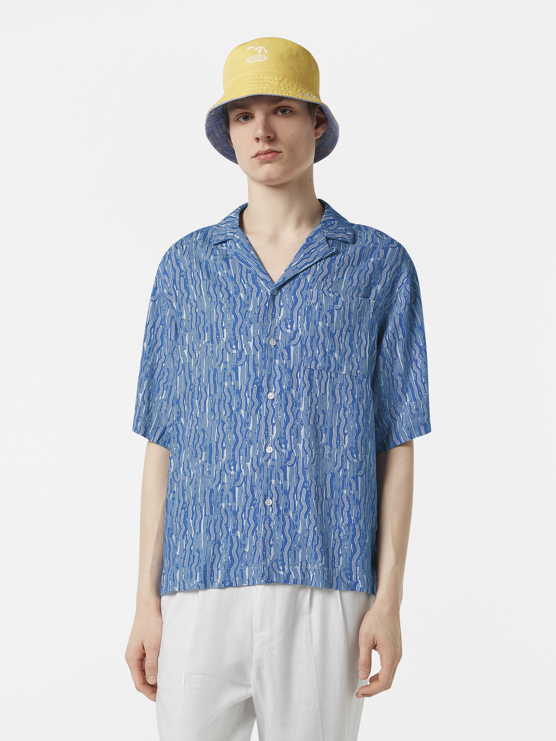 Short-sleeved printed shirt by Scotch & Soda featuring colorful floral and geometric patterns on lightweight fabric.