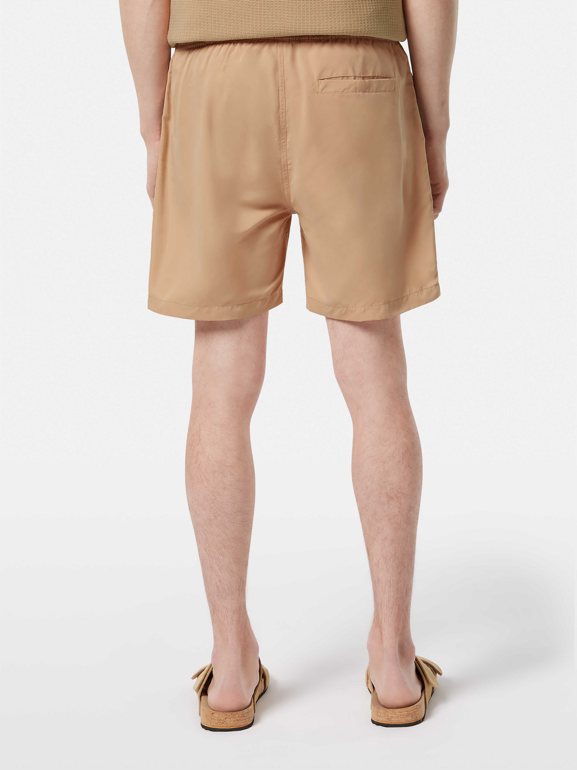 Mid-length Scotch & Soda swim shorts in vibrant print, displayed from the back view, perfect for beach or poolside wear.