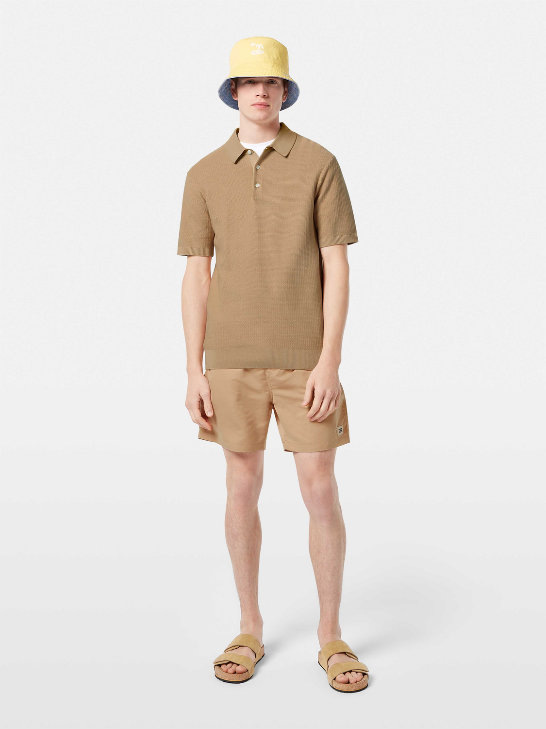 Mid-length Scotch & Soda swim shorts in vibrant fabric, displayed flat with waistband and side pockets visible.