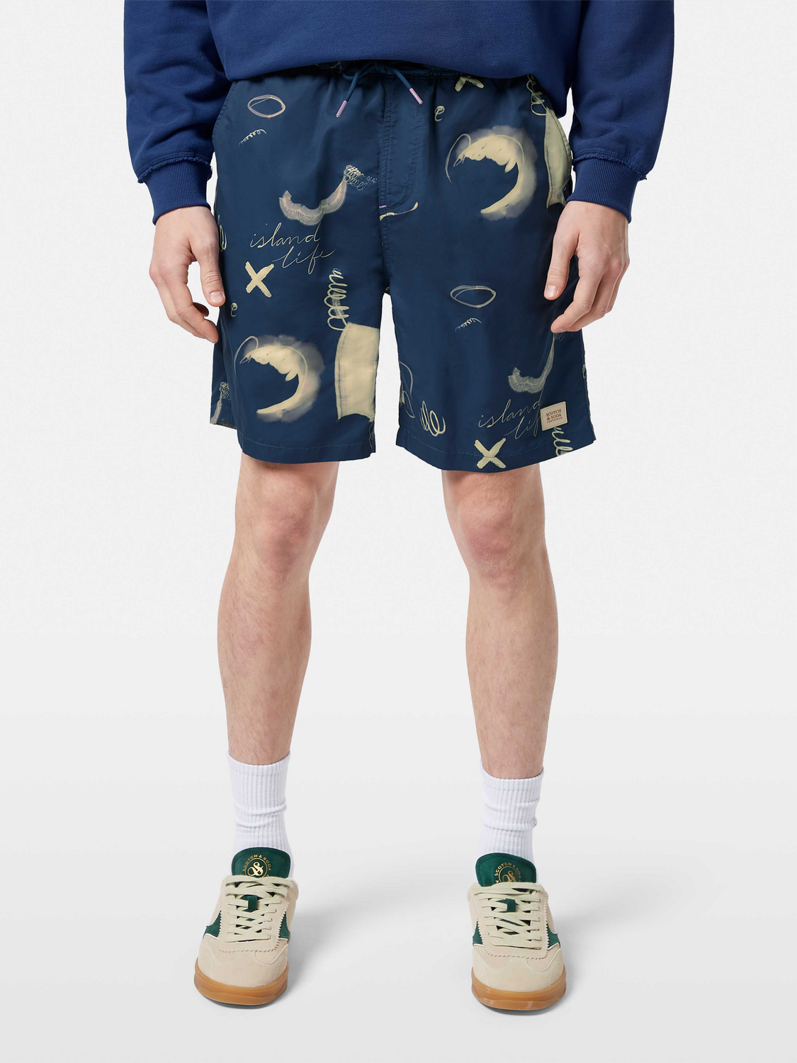 Printed Scotch & Soda swimshorts with colorful tropical pattern, lightweight swimwear for men, front view with elastic waistband