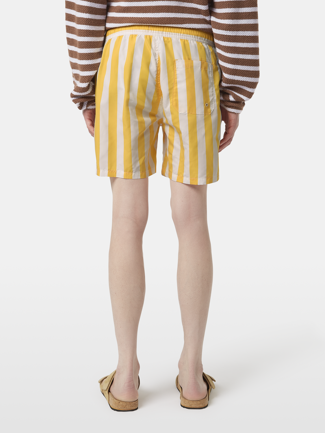 Striped swimshorts in blue and white from Scotch & Soda, stylish swimwear with a comfortable fit, back view.