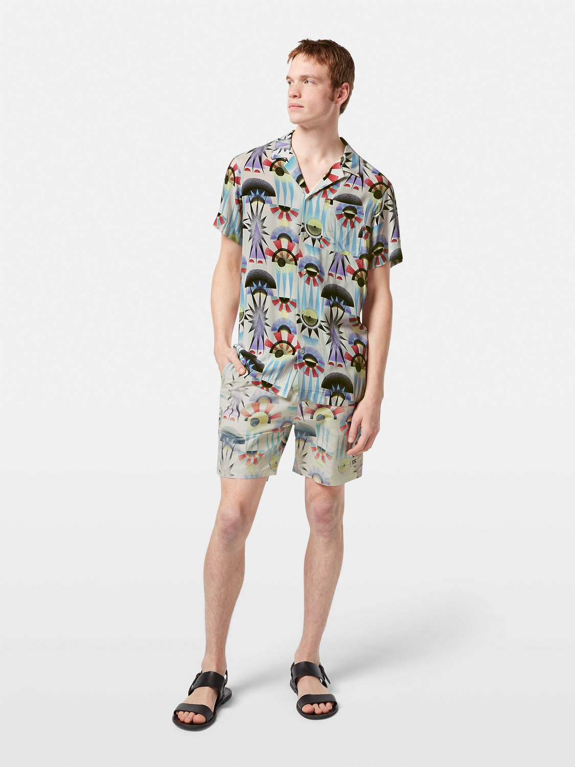 Printed short-sleeved shirt by Scotch & Soda, featuring vibrant patterns and casual fit, displayed on a hanger.