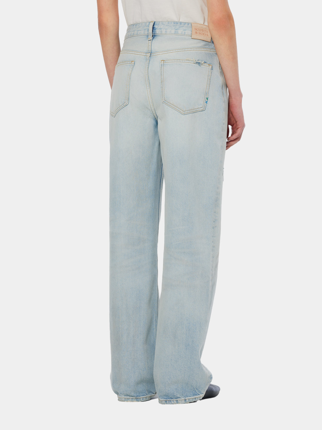 SCOTCH & SODA Ripple straight-fit denim jeans showing back view with classic five-pocket design and raw hem details.