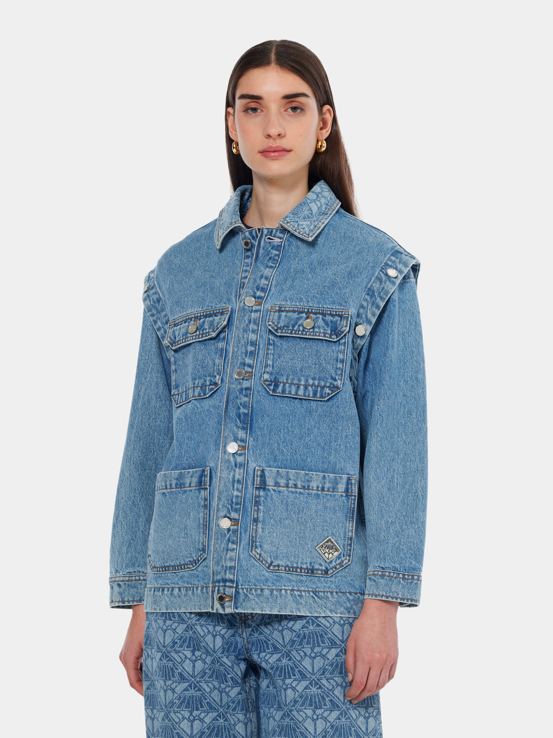 Washed denim jacket by Scotch & Soda, front view showing classic collar, button closure, and faded blue denim fabric.