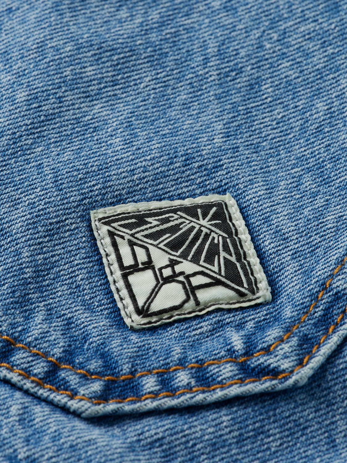 Light washed denim jacket from Scotch & Soda, featuring classic collar and button-front design, displayed on a hanger.