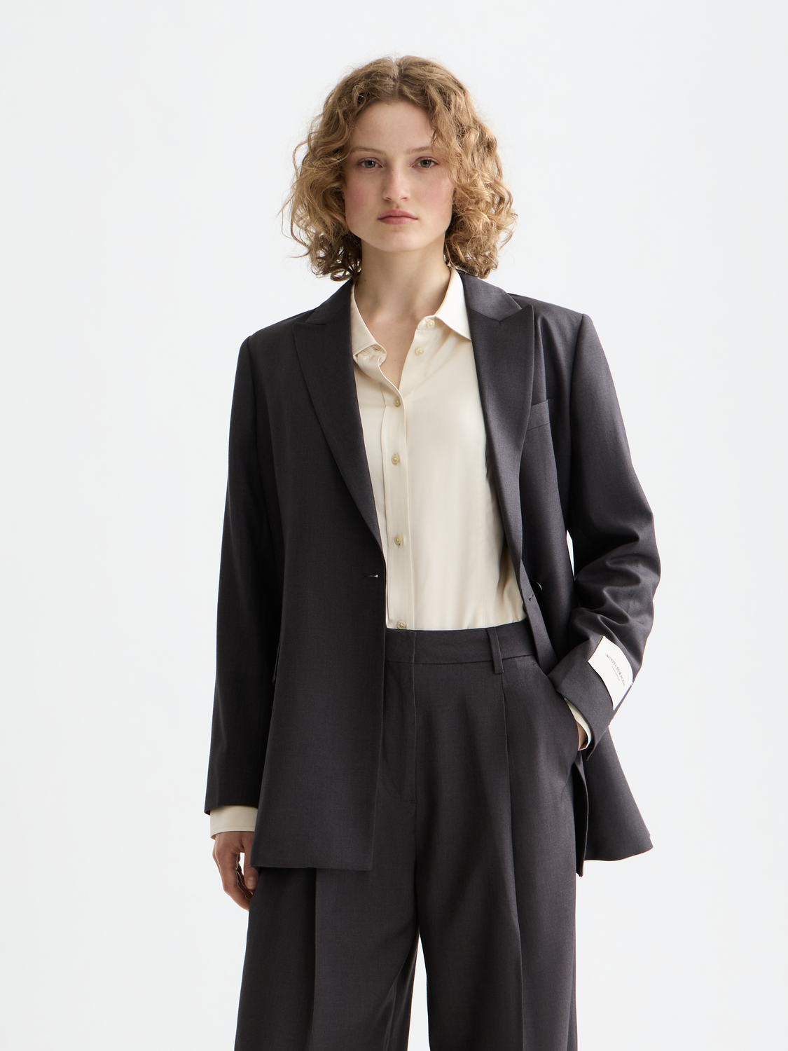 Scotch & Soda belted double-breasted blazer in dark fabric with front button closure and tailored fit.