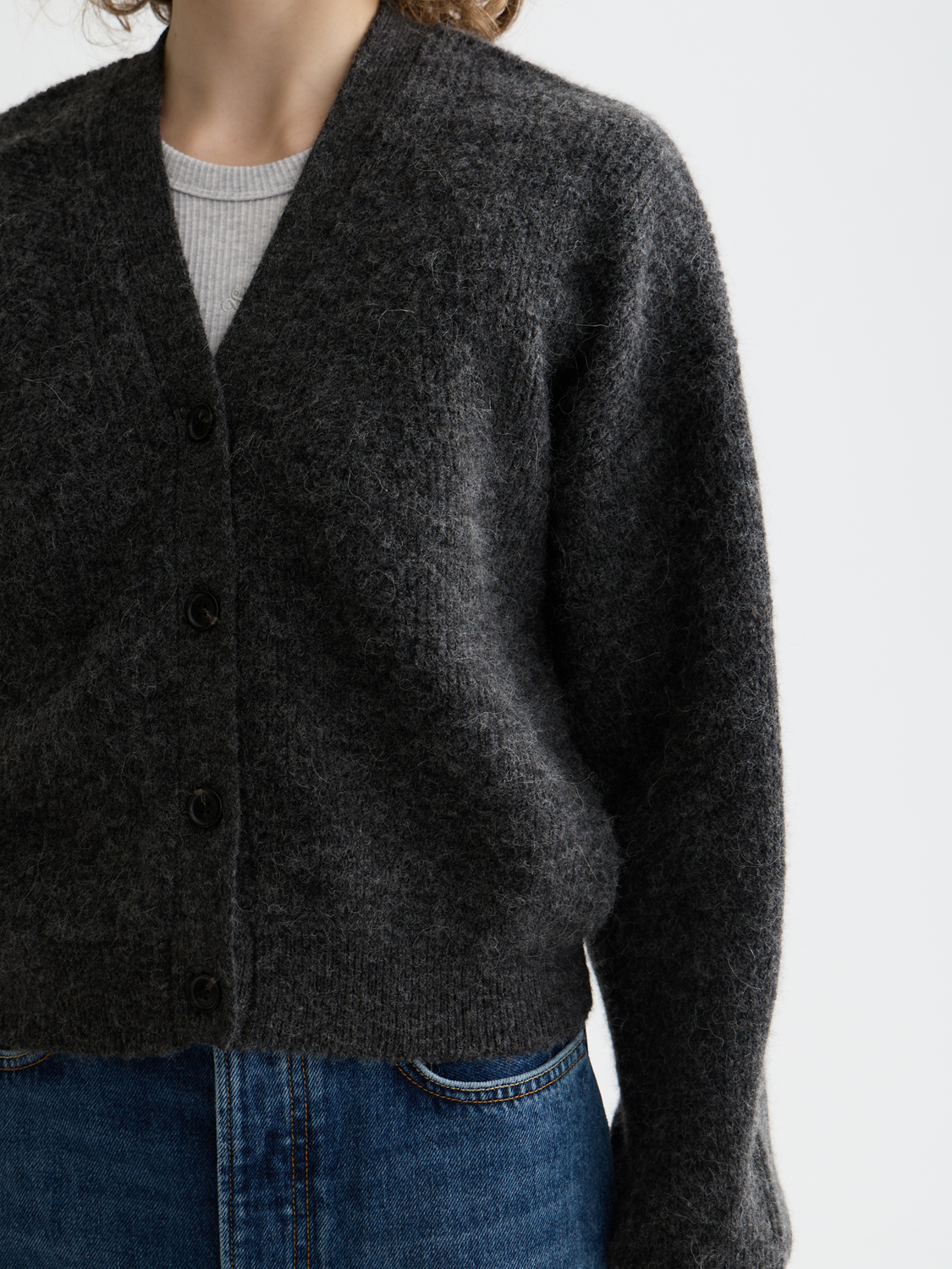 Fuzzy knit cardigan by Scotch & Soda featuring soft texture and cozy fit, worn by a model with casual styling.