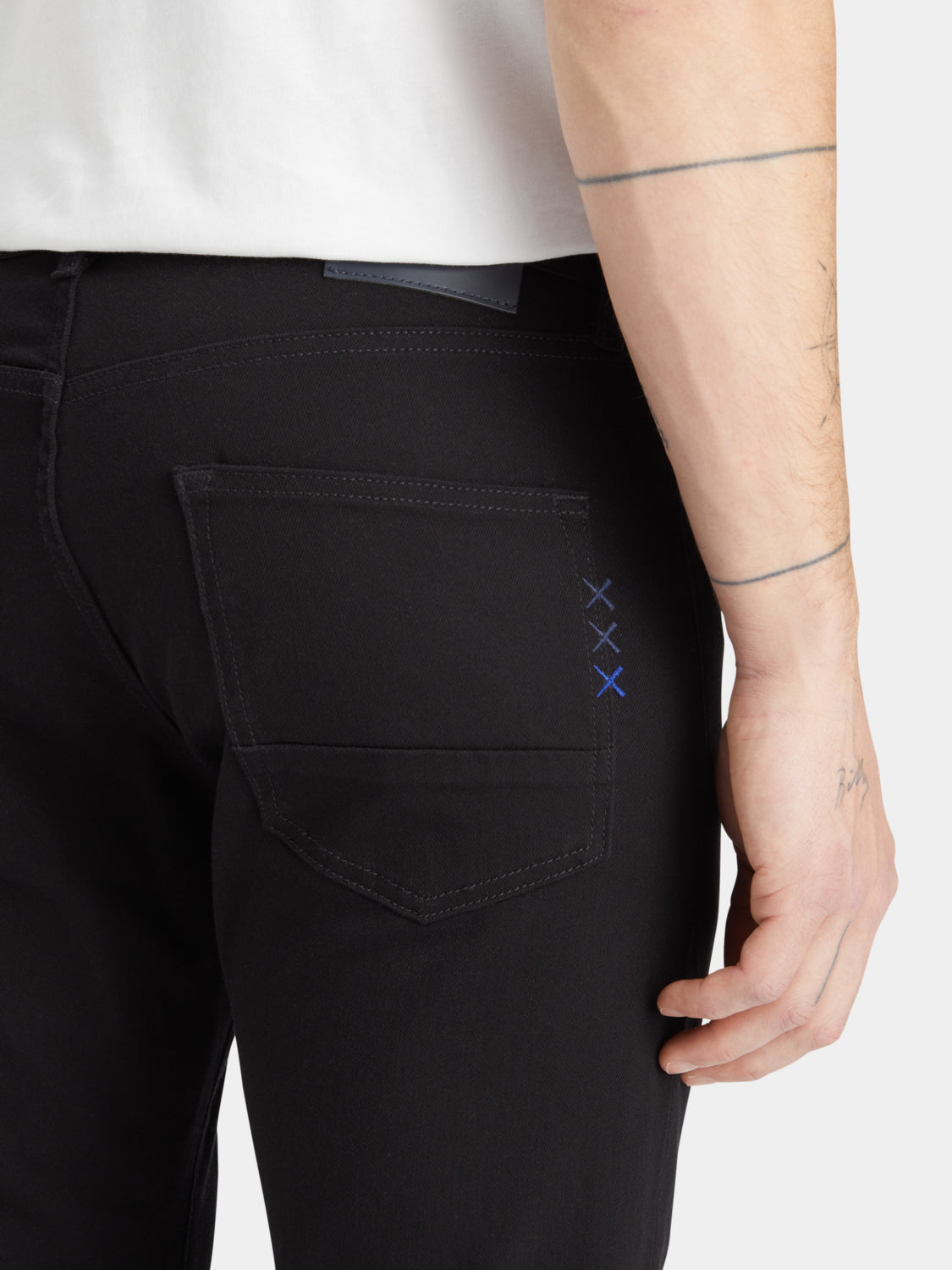 Slim-fit Ralston denim jeans by Scotch & Soda, shown hanging on a display with a classic blue wash and modern fit.