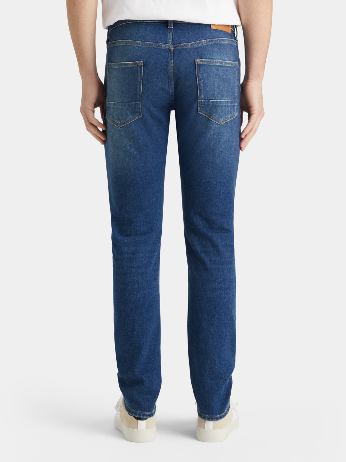 Back view of Scotch & Soda Ralston slim-fit denim jeans showing dark wash, classic pockets, and slim silhouette.