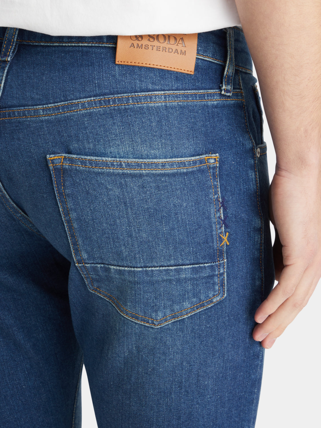 Slim-fit denim jeans by Scotch & Soda featuring classic five-pocket design and a dark wash, displayed on a model.