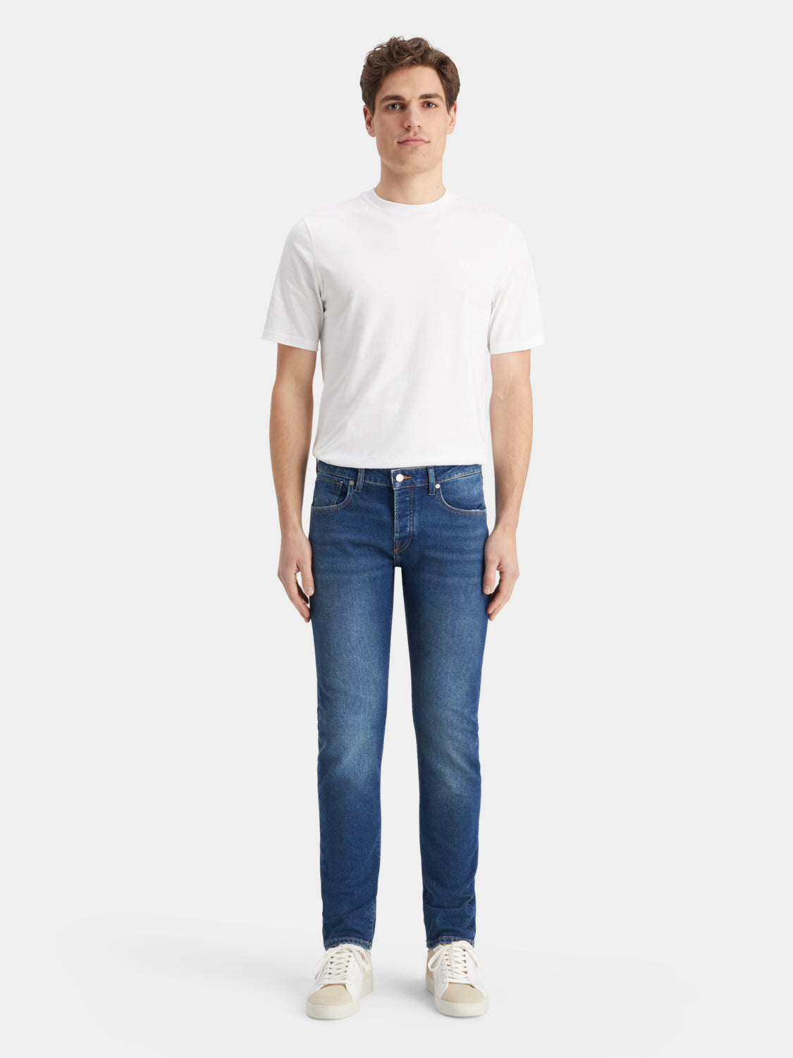 Scotch & Soda Ralston slim-fit denim jeans displayed on a model, showcasing the classic fit and dark wash fabric.