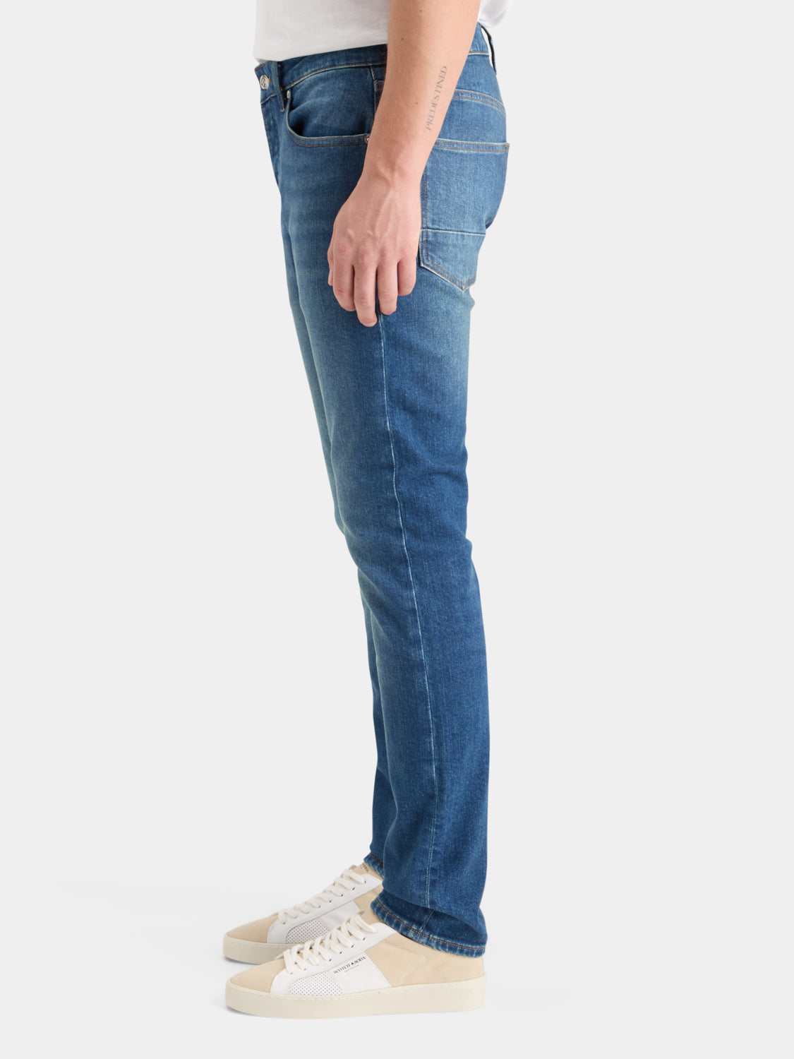 Scotch & Soda Ralston slim-fit denim jeans showcasing a classic blue wash with front pockets and belt loops.