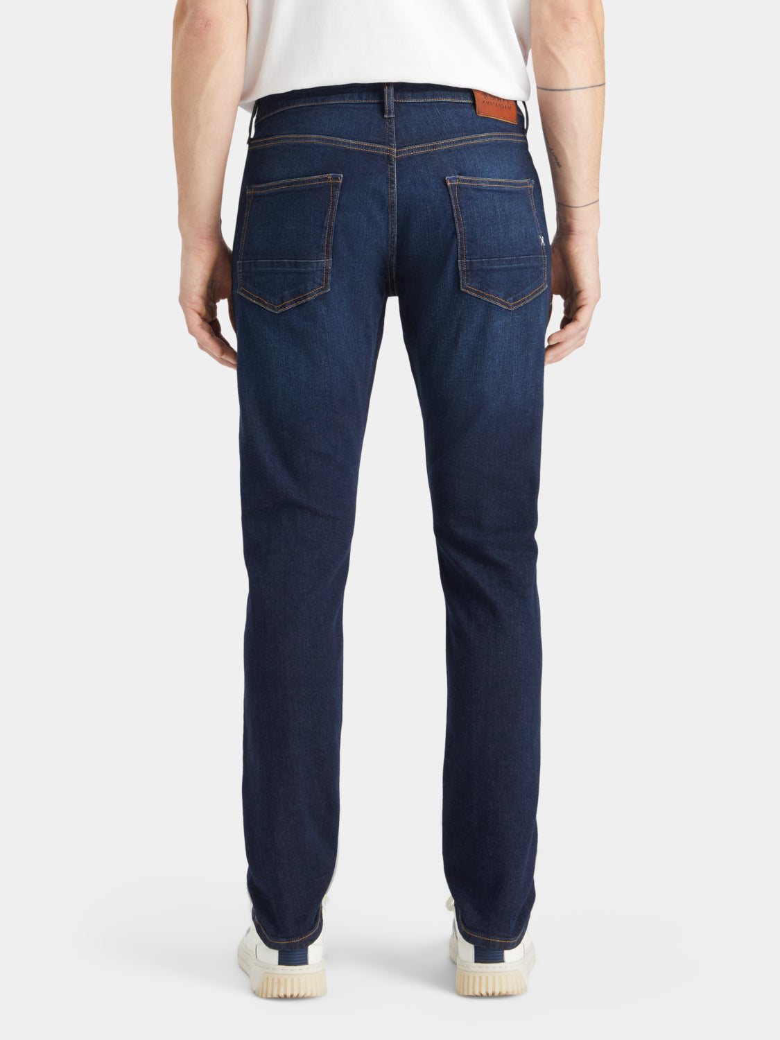 Back view of Ralston slim-fit denim jeans by Scotch & Soda, showcasing dark wash and classic five-pocket design.