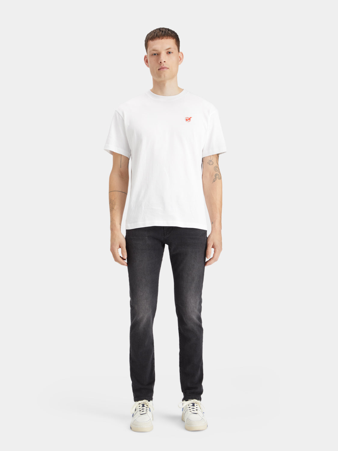 Slim-fit denim jeans by Scotch & Soda with classic five-pocket design and dark wash, shown on a model.