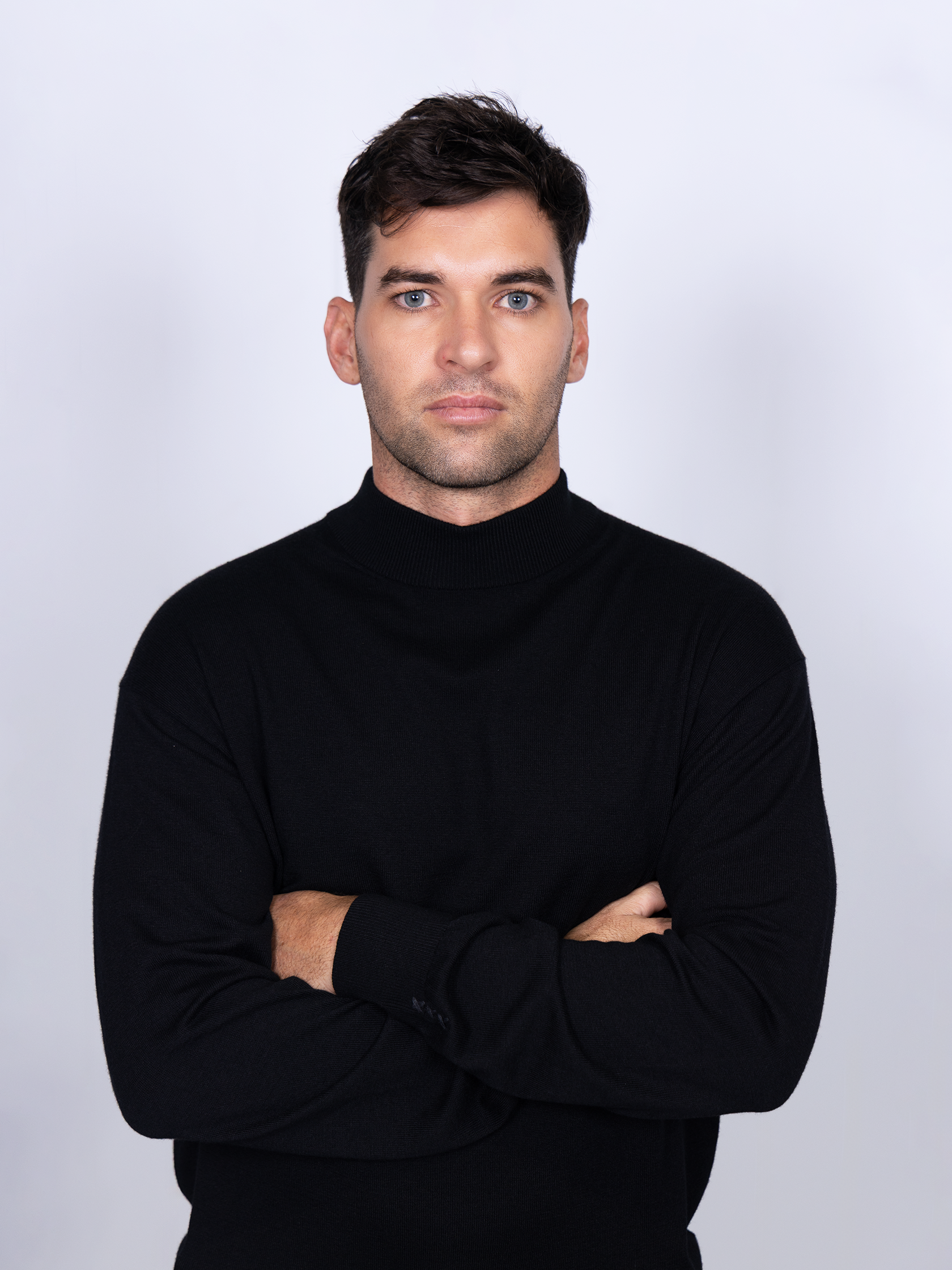 Close-up of a navy knitwear mock neck sweater from Scotch & Soda, showcasing soft, stretchy fabric and classic design.