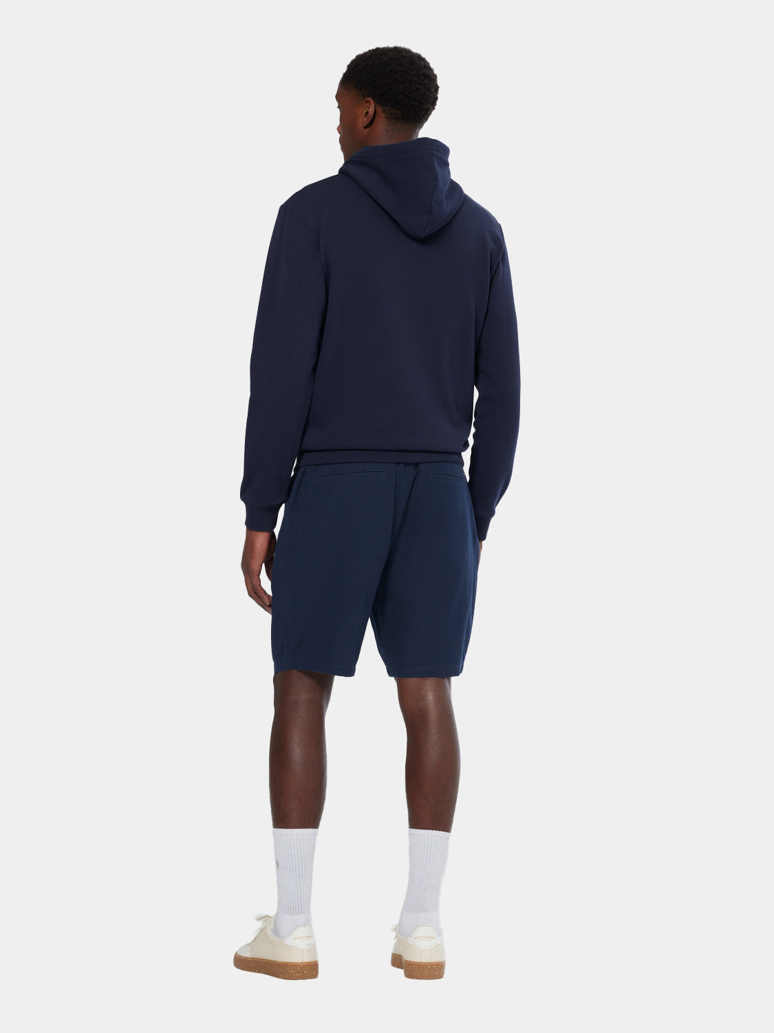 Black hoodie with Scotch & Soda logo on the front, casual sweat style, model wearing the logo hoodie in a relaxed setting.