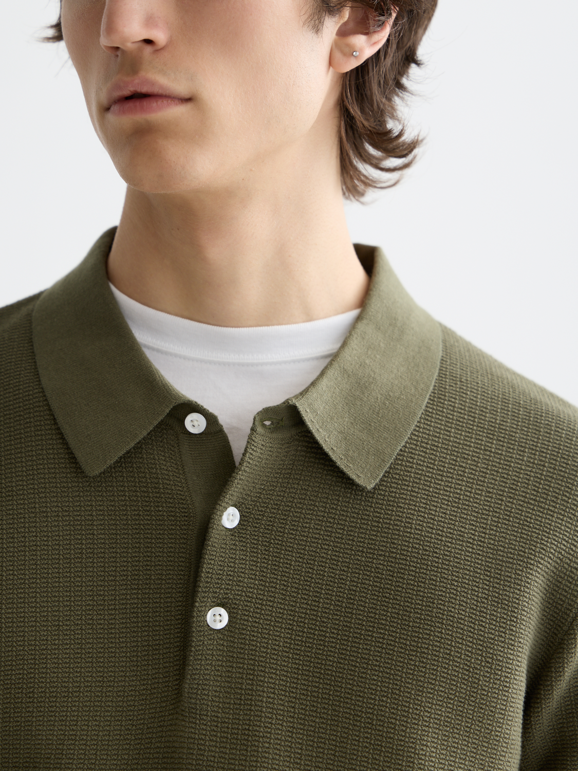 Scotch & Soda knitted polo shirt in navy with a classic collar and button front, displayed on a neutral background.