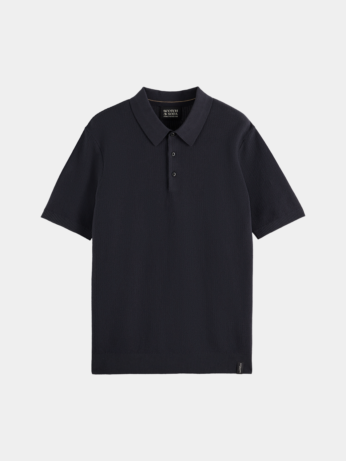 Blue knitted polo shirt by Scotch & Soda with a classic collar and short sleeves, displayed on a neutral background.