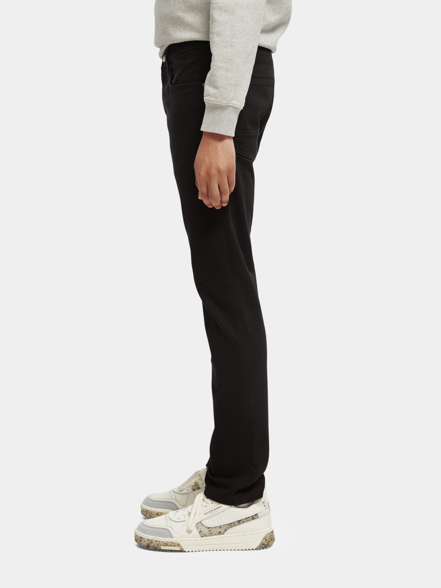 Slim fit denim jeans by Scotch & Soda, Ralston style, shown in a natural pose highlighting the classic blue color and tailored fit.