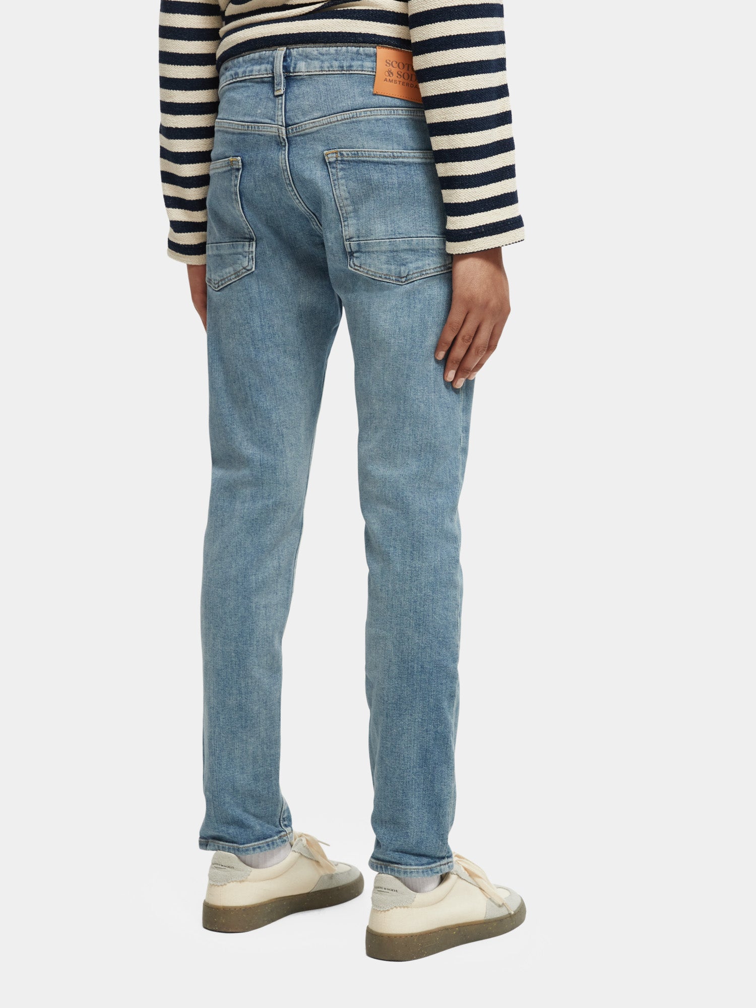 Dark blue Ralston slim fit denim jeans by Scotch & Soda, shown from the back with classic five-pocket design.