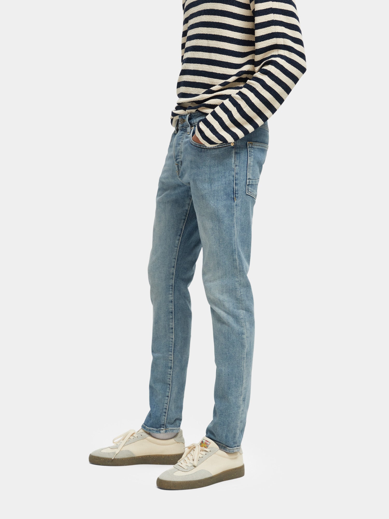 Slim fit denim jeans by Scotch & Soda, featuring classic five-pocket design and dark wash, shown on a model.