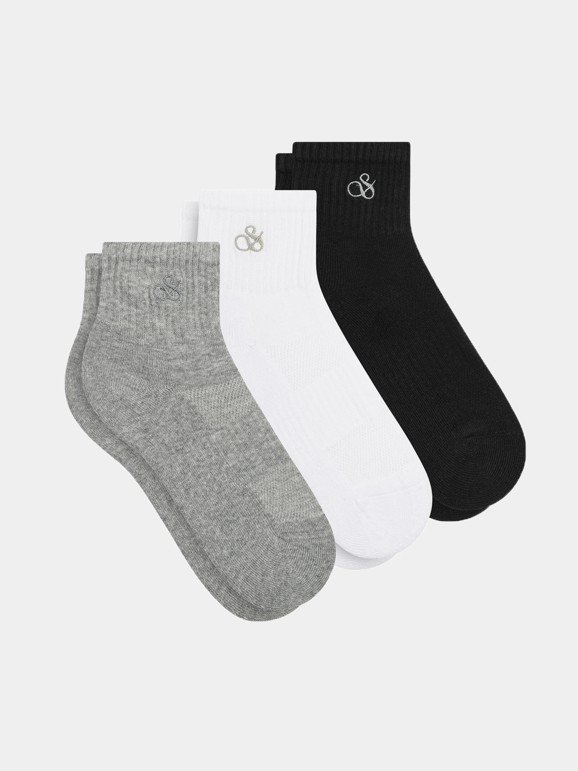 Three-pack quarter crew socks by Scotch & Soda, featuring various colors and designs, displayed laid out flat.