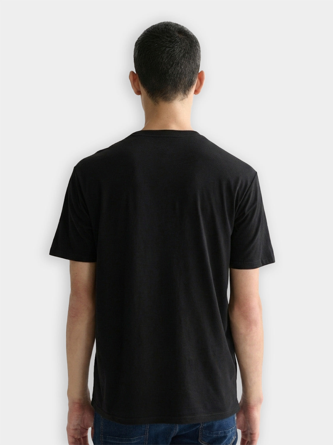 Three Scotch & Soda crew neck short sleeve T-shirts in neutral colors, displayed folded with one partially unfolded showing the fabric.