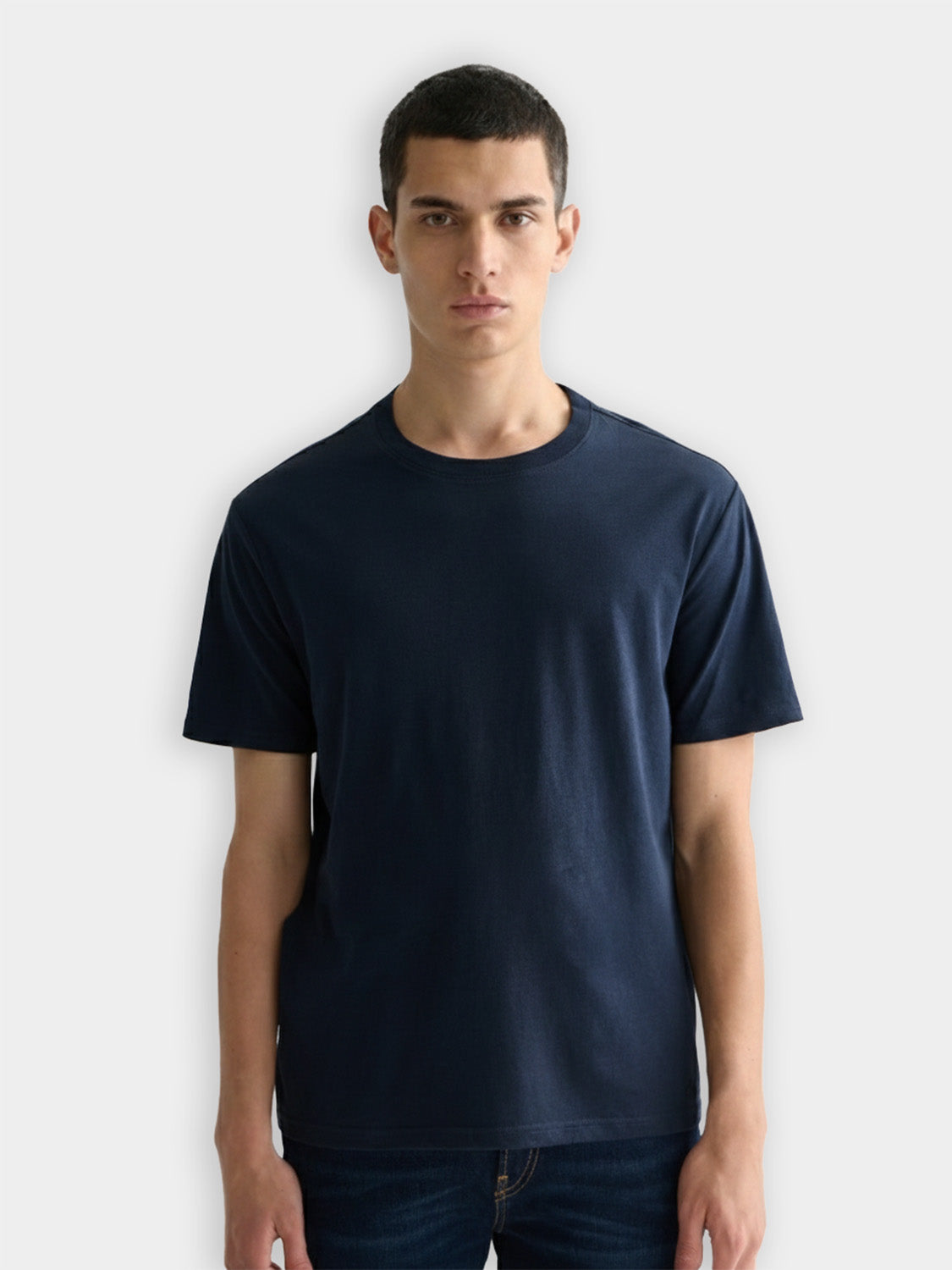 Three Scotch & Soda short-sleeve crew neck T-shirts in neutral colors, laid out flat for display.