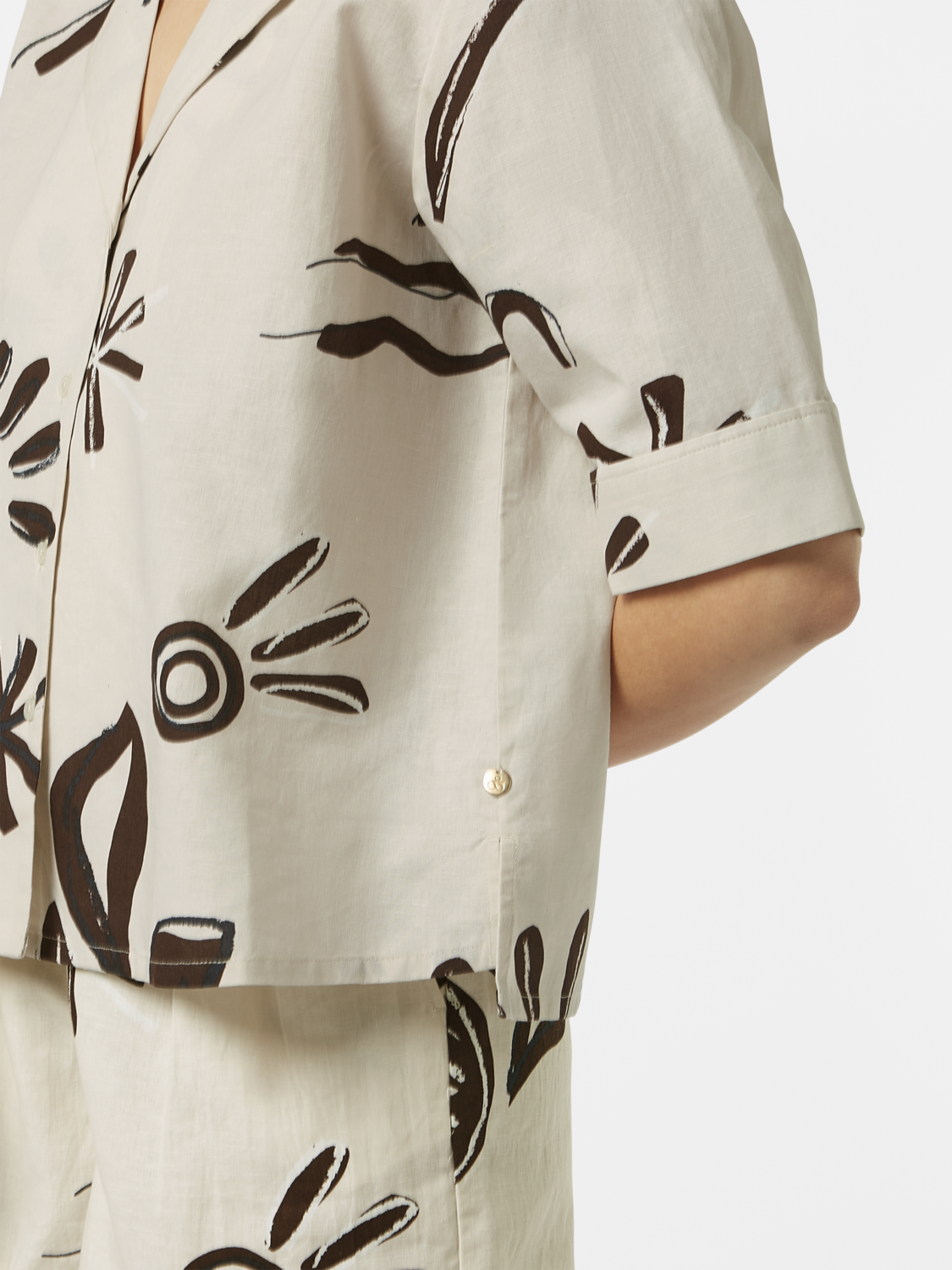 Printed short-sleeved shirt by Scotch & Soda, featuring a colorful pattern and classic fit, displayed on a model.