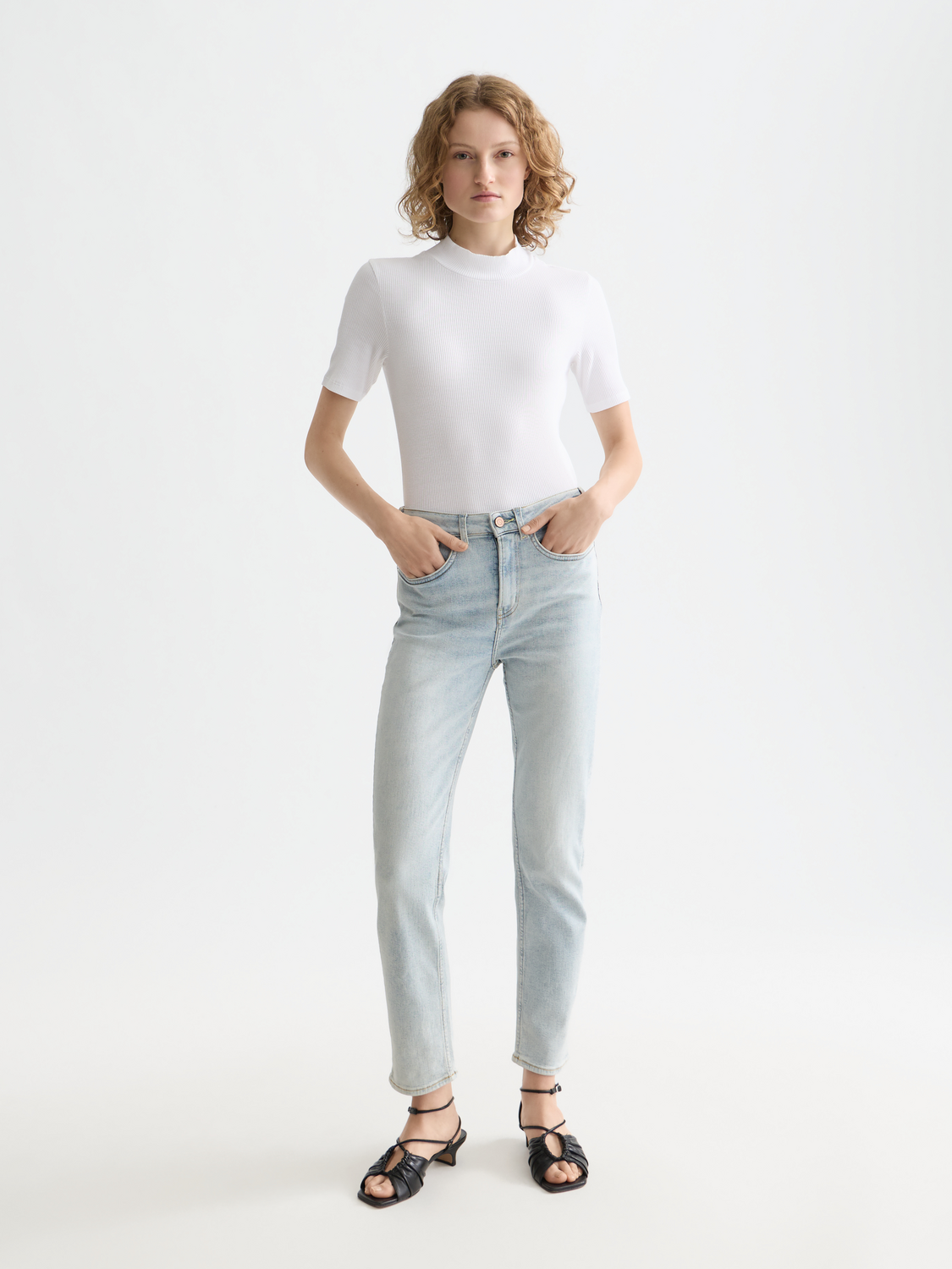 Light beige ribbed mock neck short-sleeve tee from Scotch & Soda, showing the fitted neckline and textured fabric.