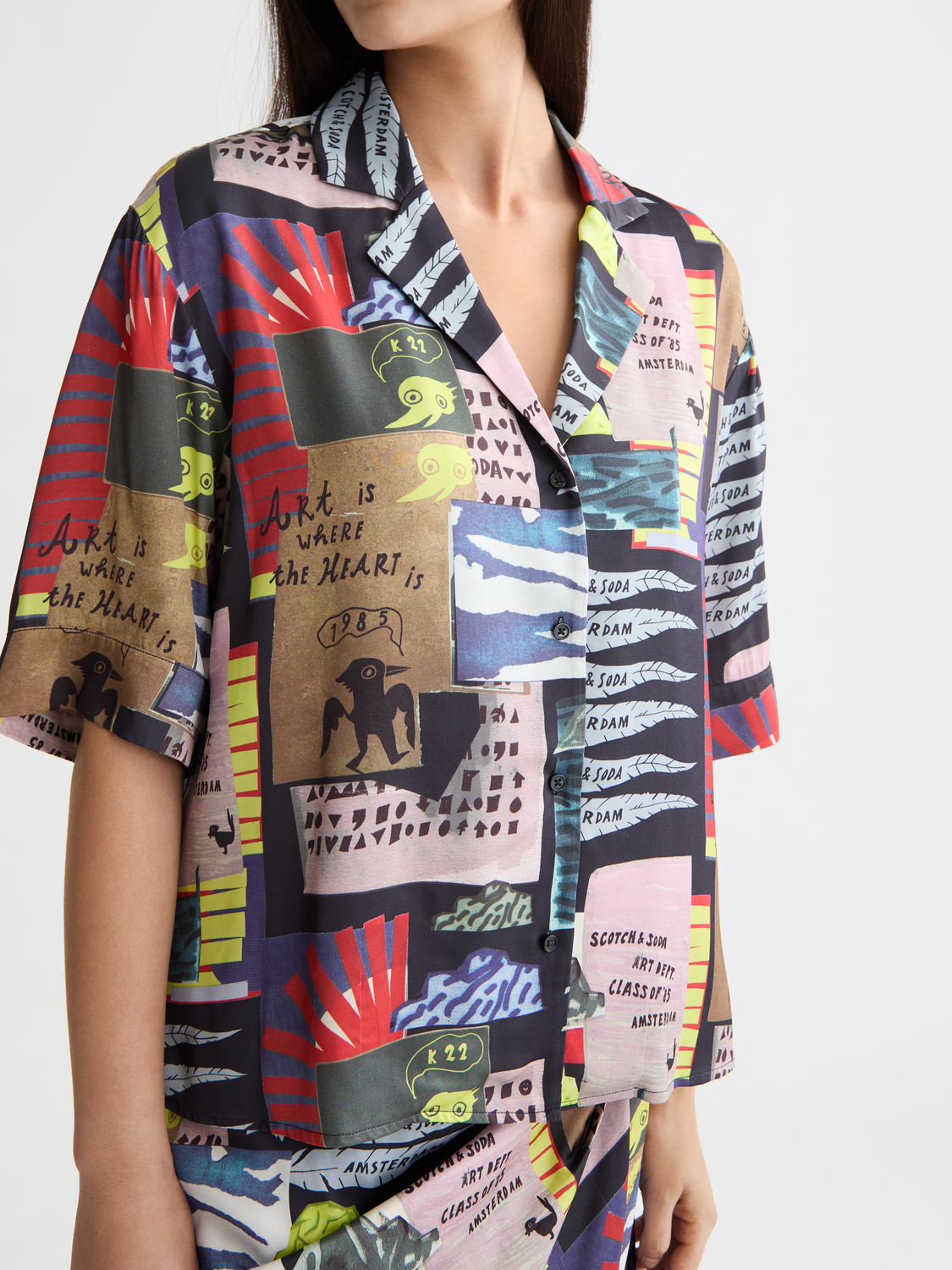 Printed short-sleeved shirt by Scotch & Soda with floral design, casual fit, and button-up front, displayed on a neutral background.