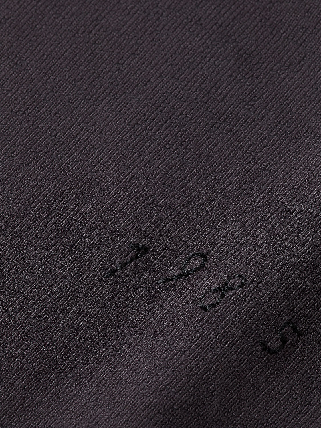 Knitted Spencer top by Scotch & Soda, showcasing a cozy knitwear design in a close-up view.