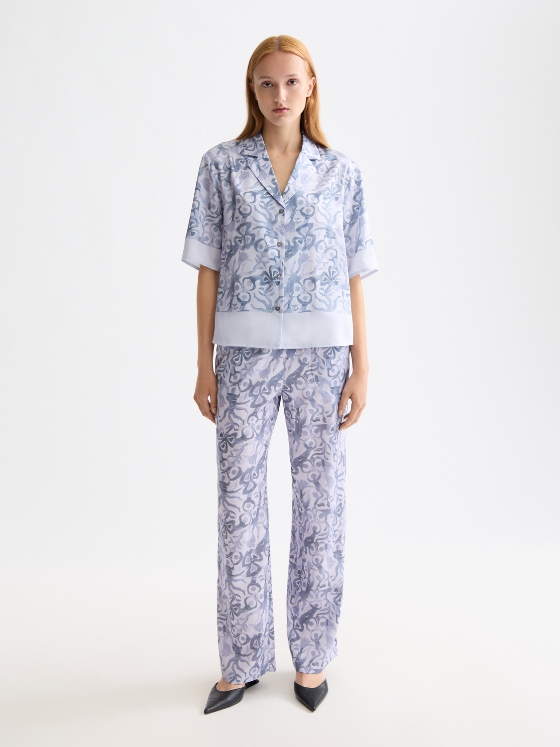 Printed short-sleeved shirt by Scotch & Soda featuring vibrant patterns and a classic fit, displayed on a model.