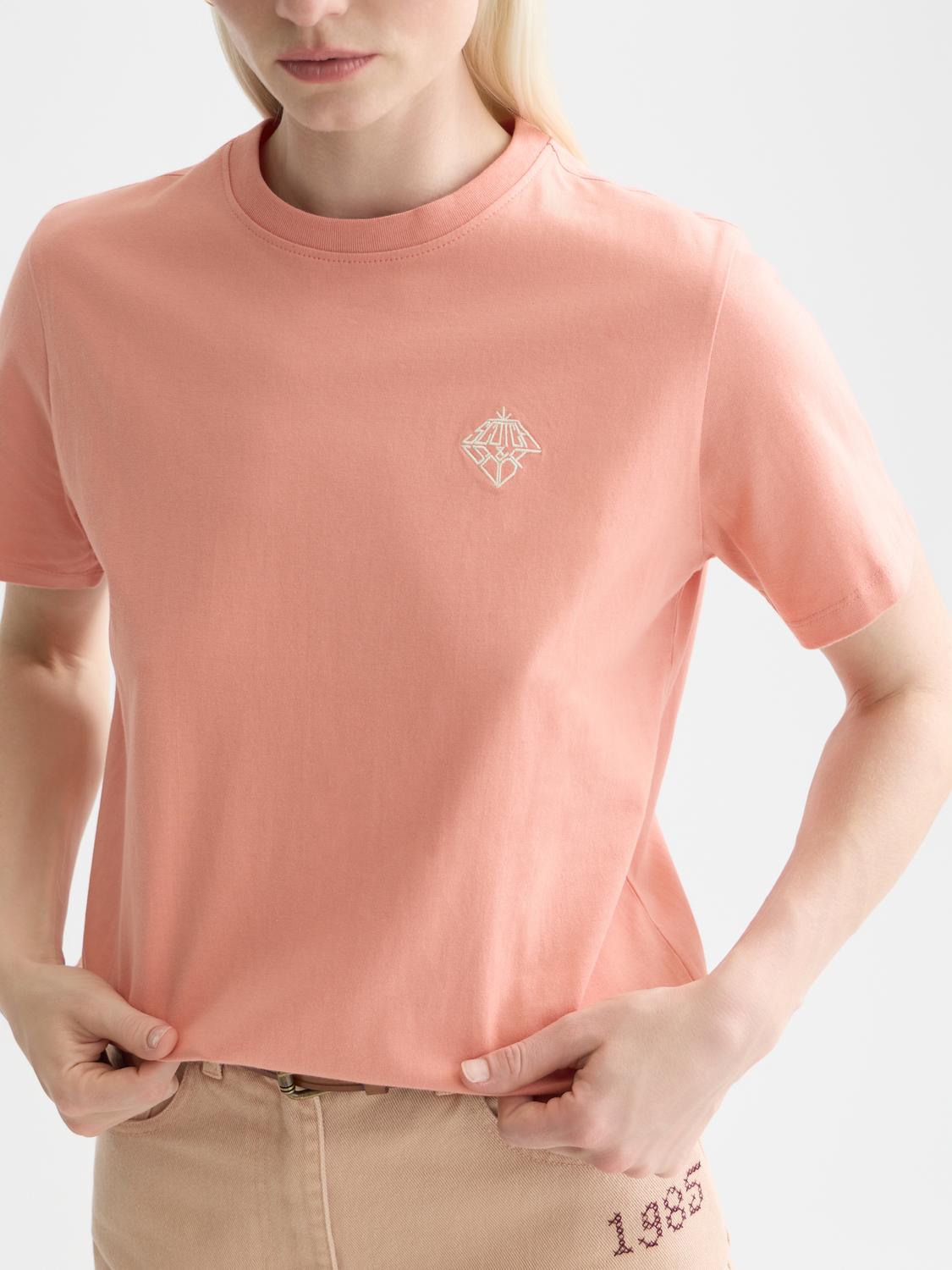 Light blue embroidered Scotch & Soda short-sleeve t-shirt with colorful floral design on front, casual and stylish.