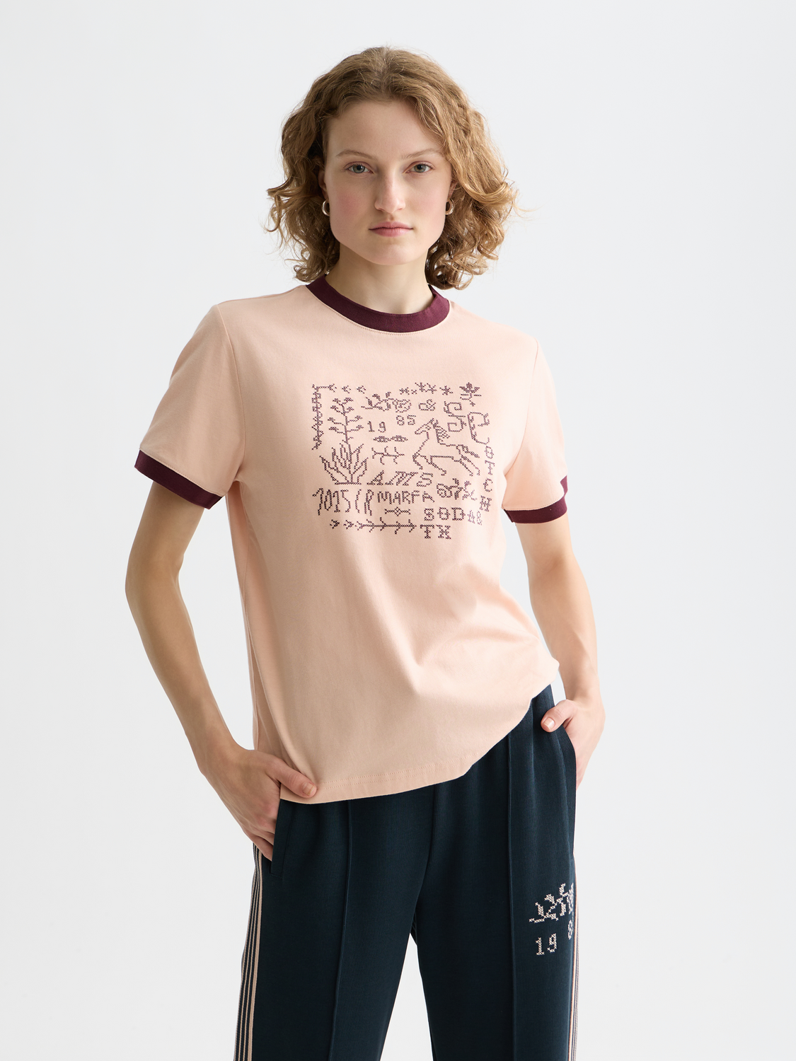 Embroidered Scotch & Soda short-sleeve ringer T-shirt with colorful embroidery on white cotton fabric.