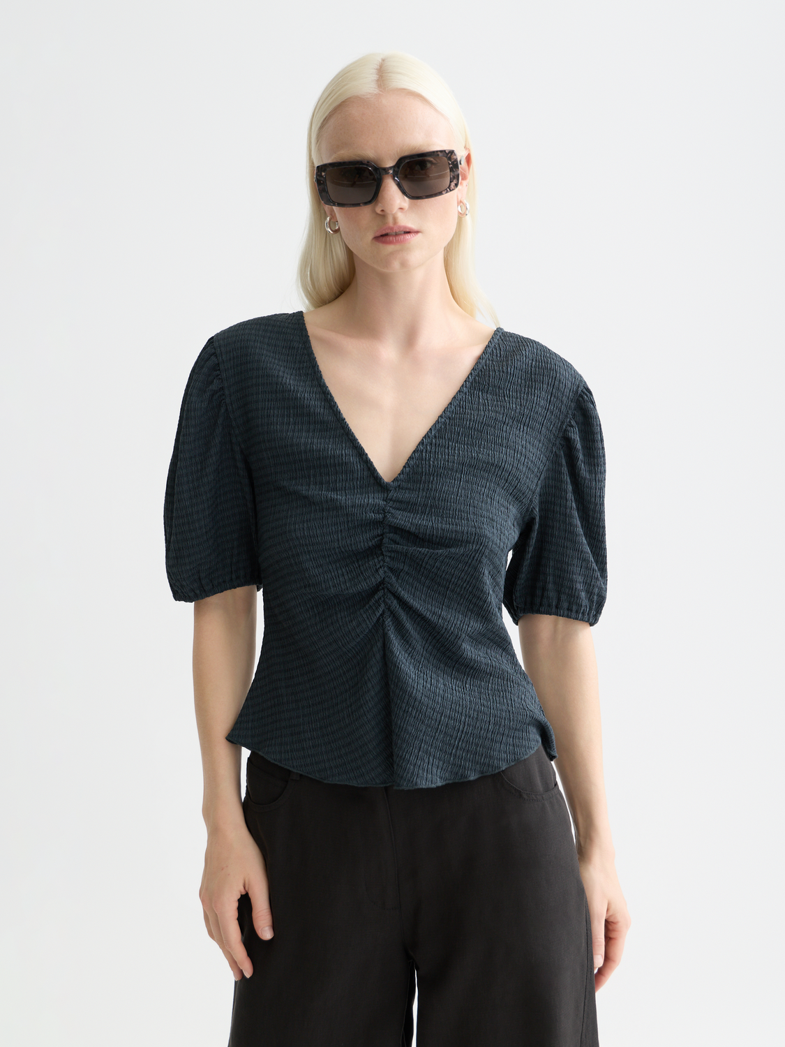 Structured v-neck top from Scotch & Soda, short sleeve tee with a fitted design, shown in a neutral color.