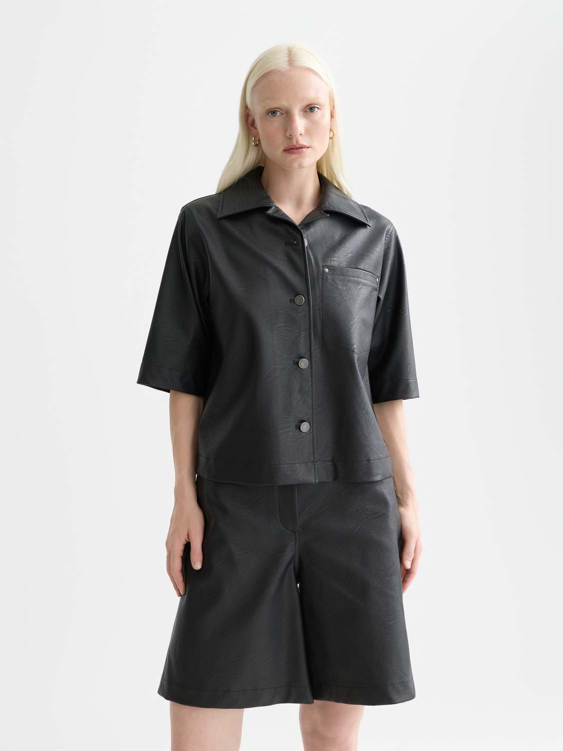 Faux leather short-sleeve shirt from Scotch & Soda, stylish black shirt with collar and button front detail.