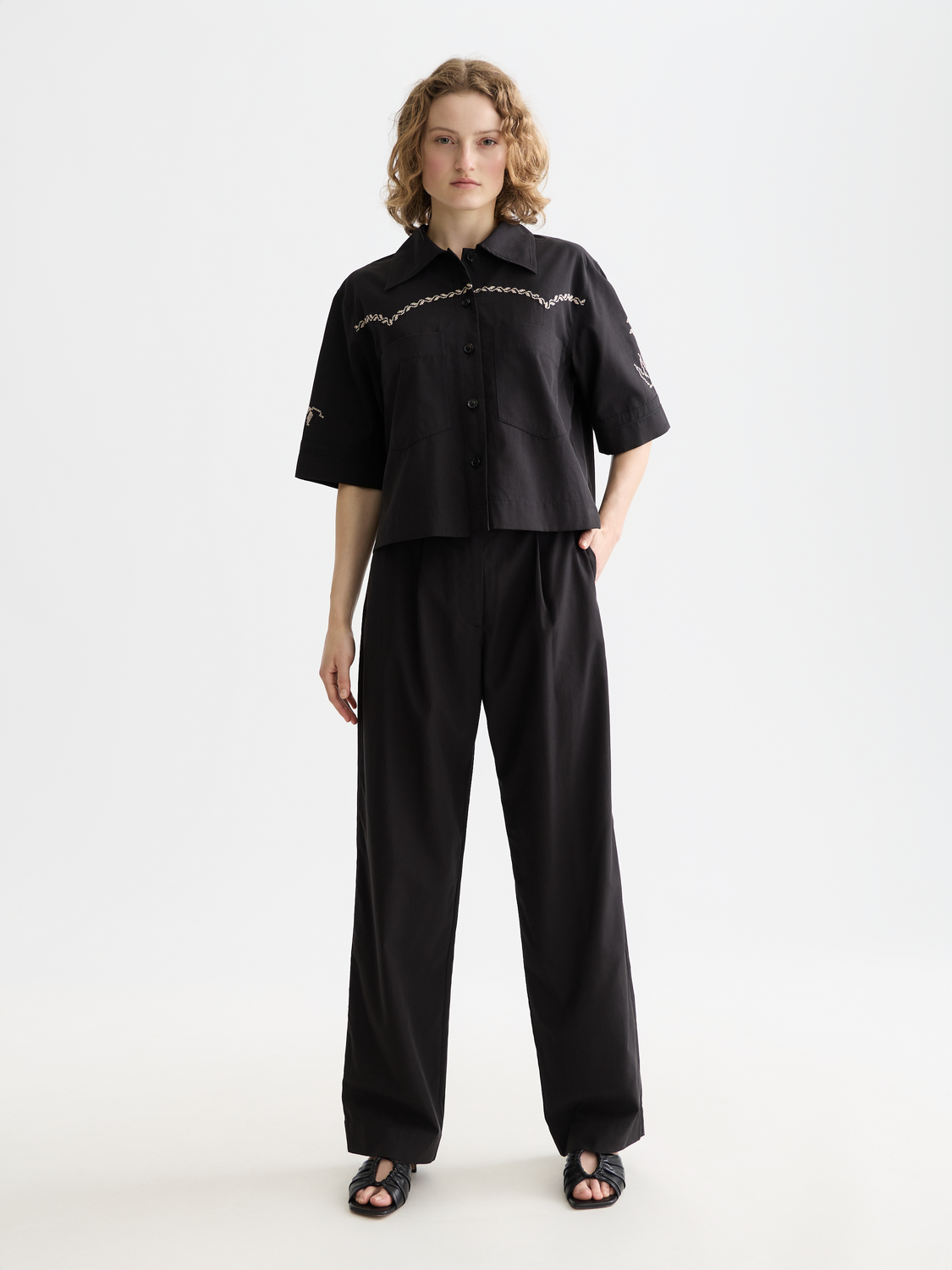 Short-sleeved Scotch & Soda men's shirt with a button-up front and classic collar, displayed on a hanger.