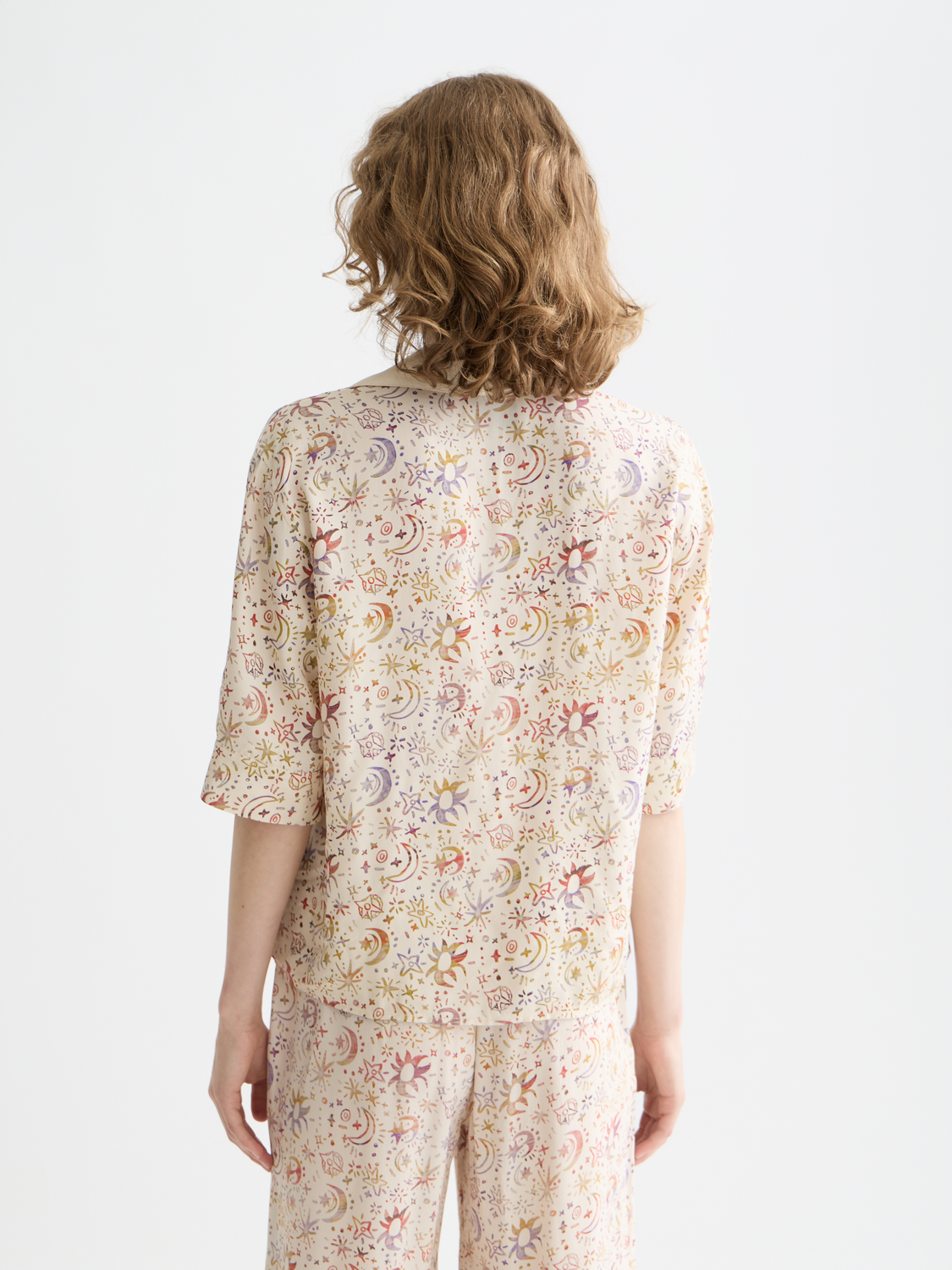 Short-sleeve printed Scotch & Soda shirt with colorful floral pattern, shown from the back view.