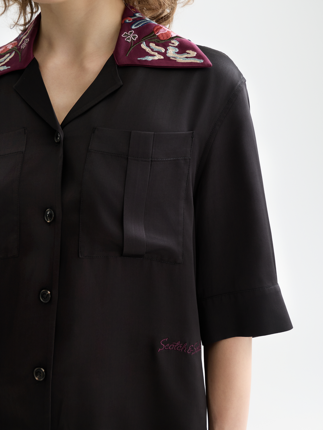 Embroidered Scotch & Soda short sleeve shirt with floral patterns, lightweight fabric, and button-up front on a neutral background.