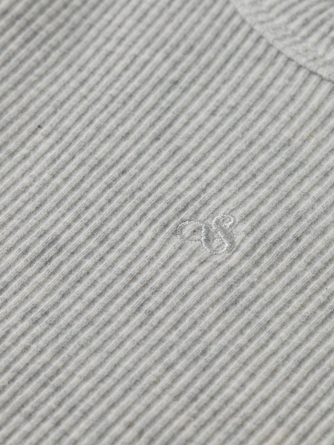 Ribbed racer tank top in neutral color from Scotch & Soda, featuring a fitted sleeveless design and ribbed texture.